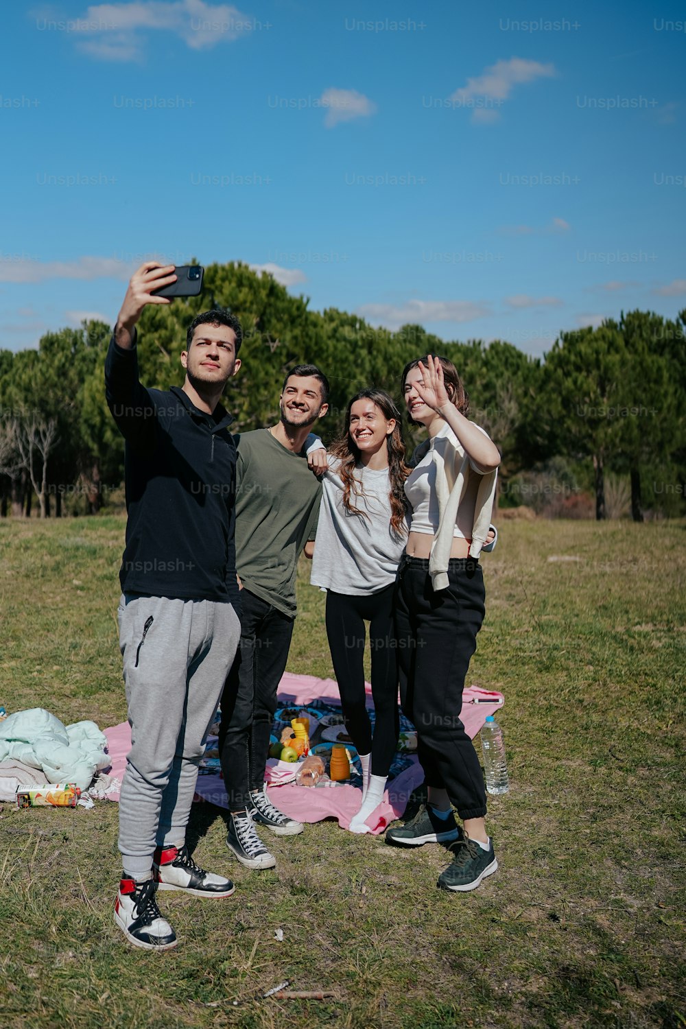 a group of people standing on top of a grass covered field