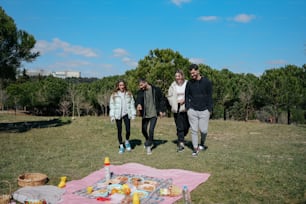 a group of people standing on top of a lush green field