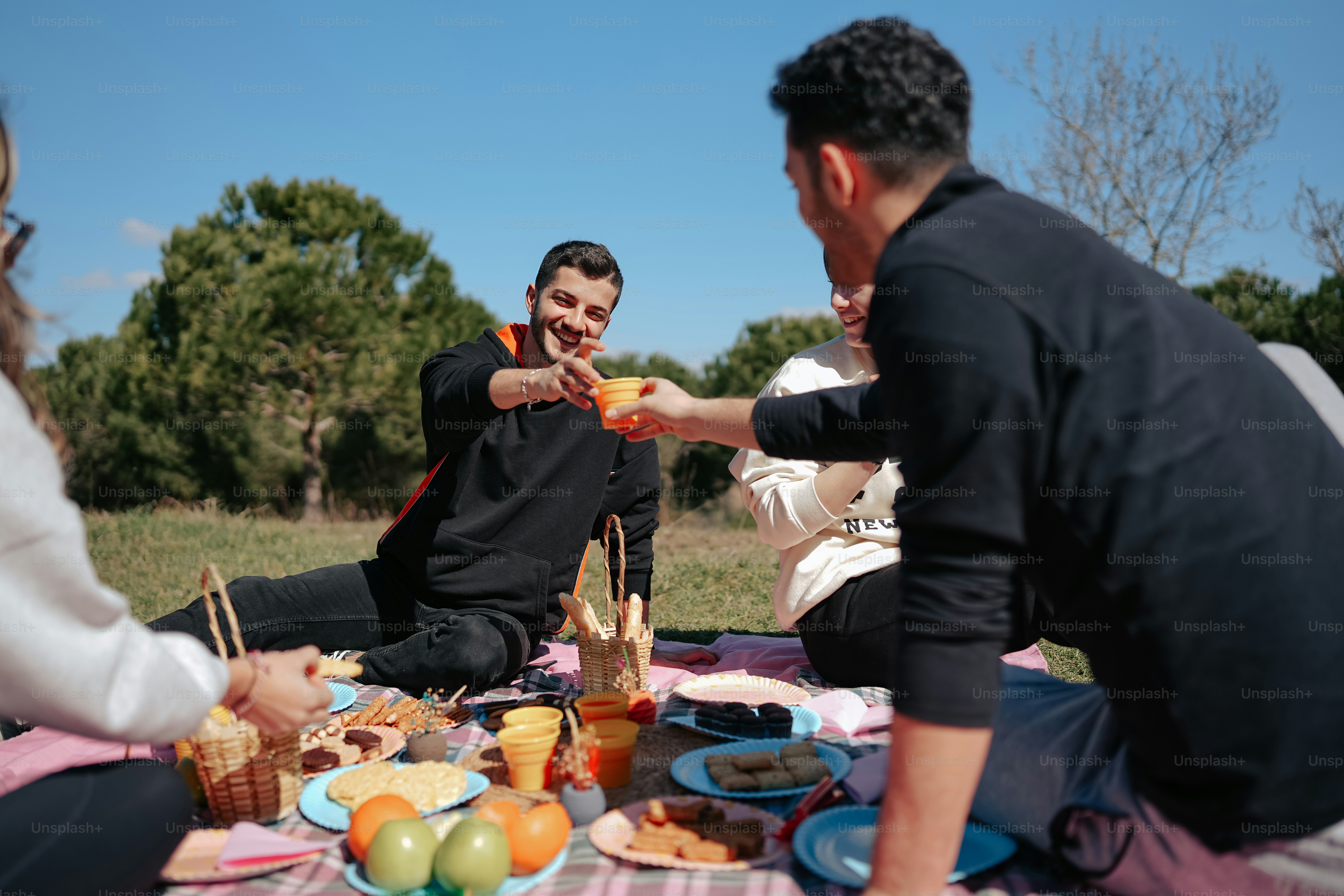 a group of people sitting around a table with food on it