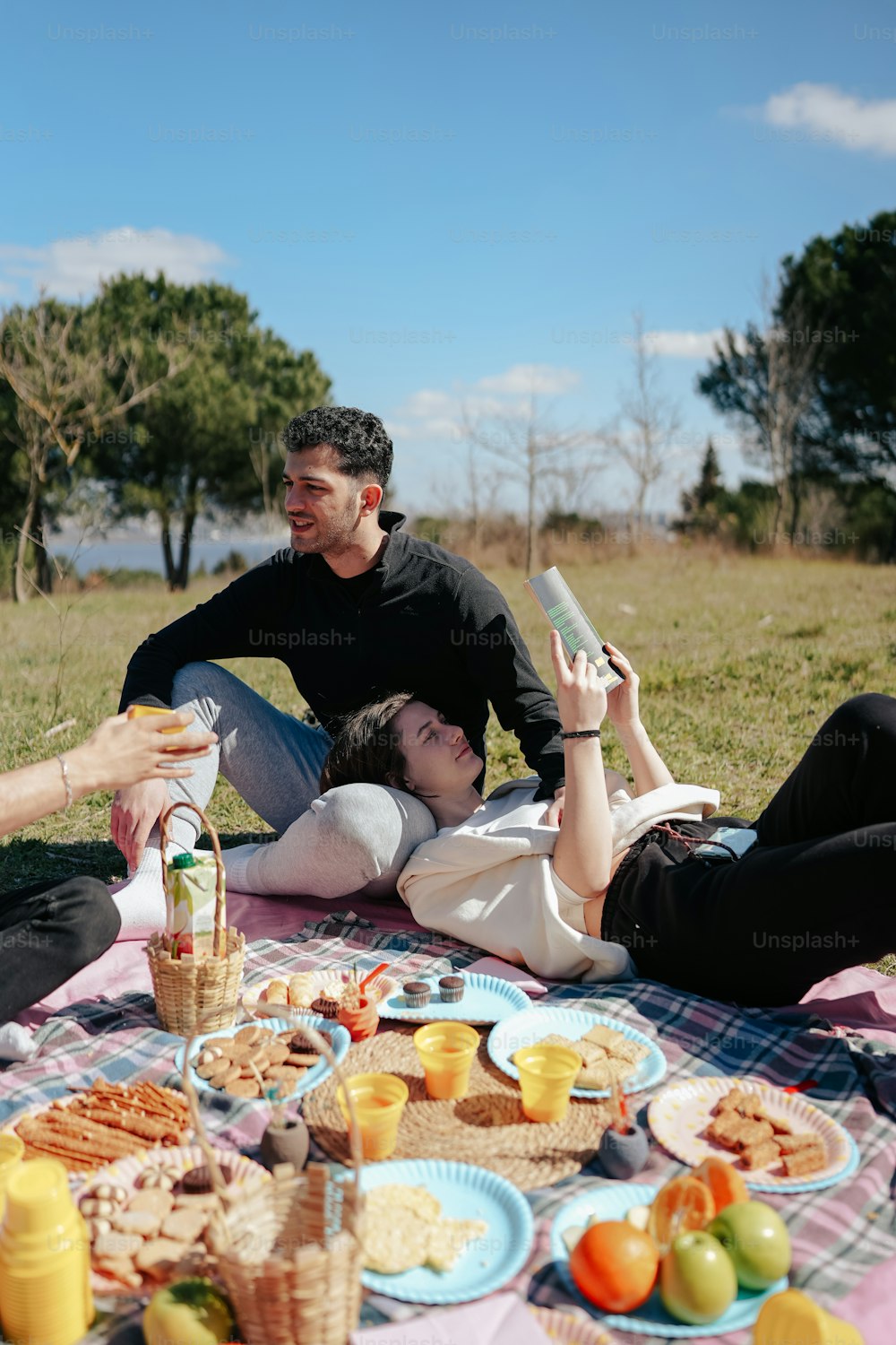 a couple of people that are laying down on a blanket