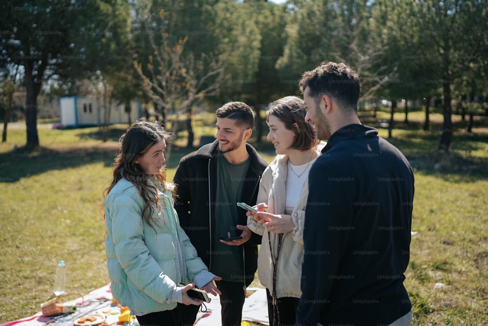 a group of people standing around a picnic table