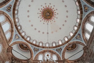 the ceiling of a large building with a chandelier