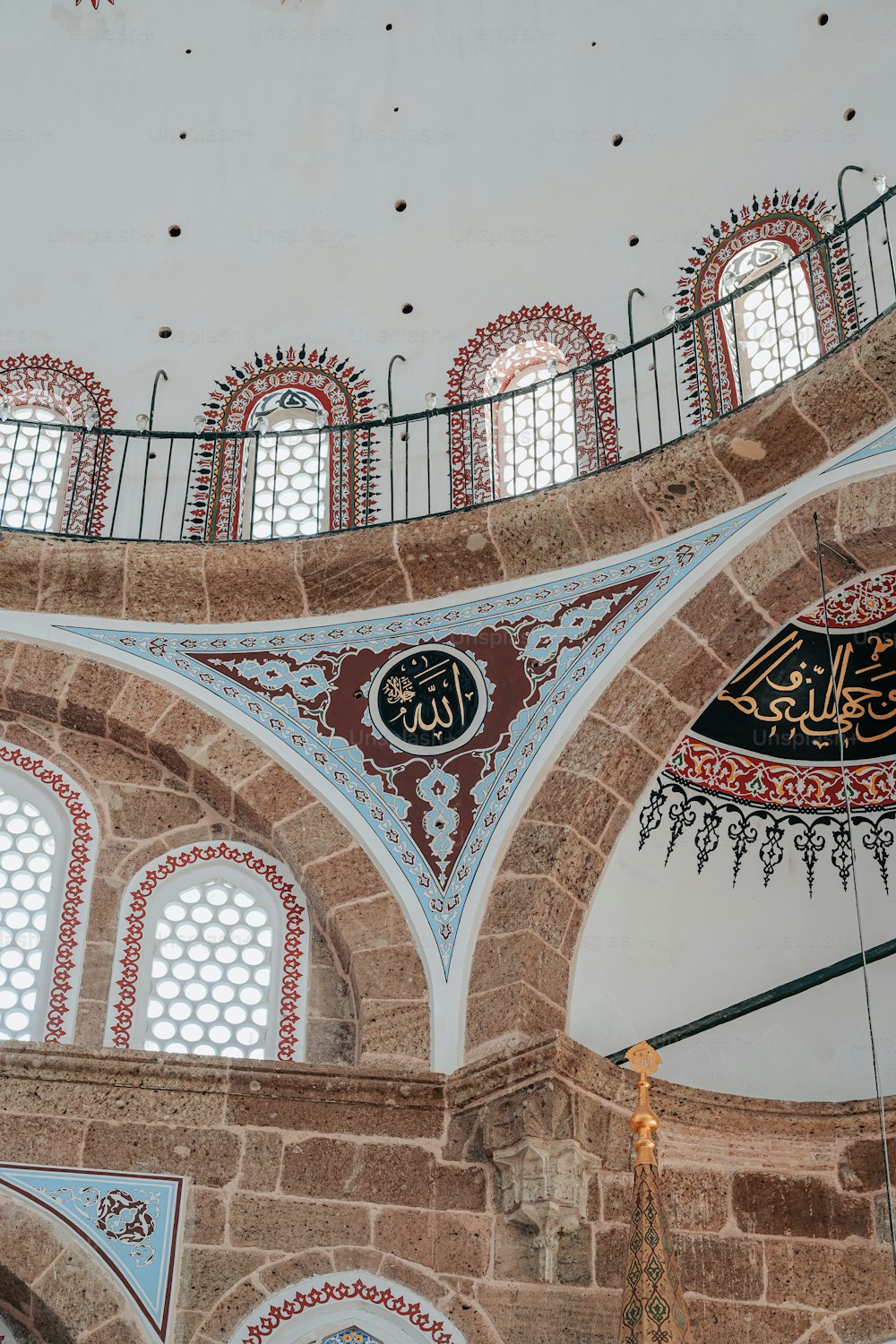 the ceiling of a large building with many windows