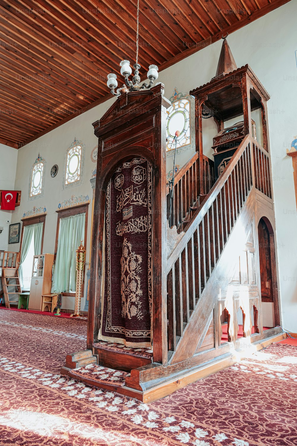 a large wooden grandfather clock sitting on top of a carpeted floor