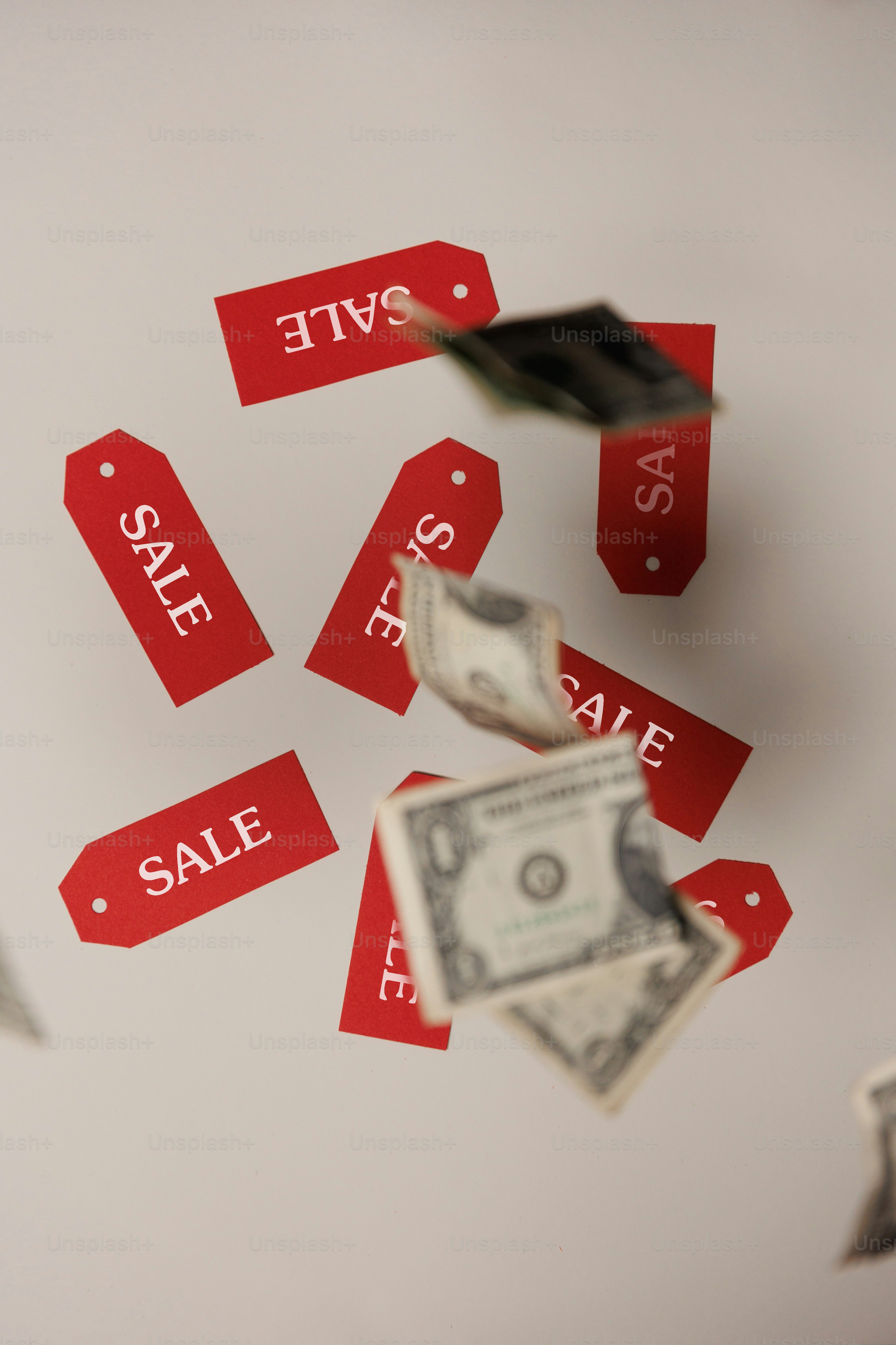a bunch of red price tags flying through the air