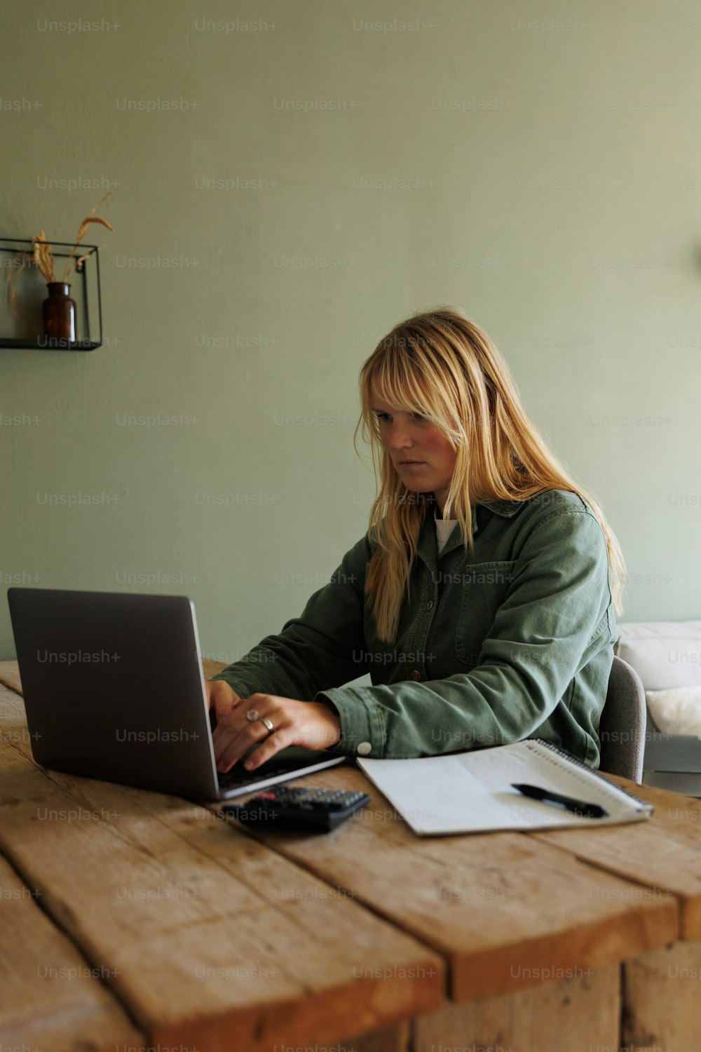 �노트북 컴퓨터를 사용하여 테이블에 앉아 있는 여자