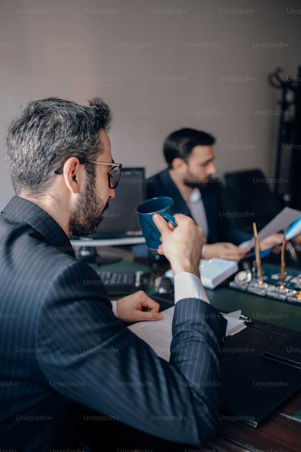 a man sitting at a desk in front of a computer