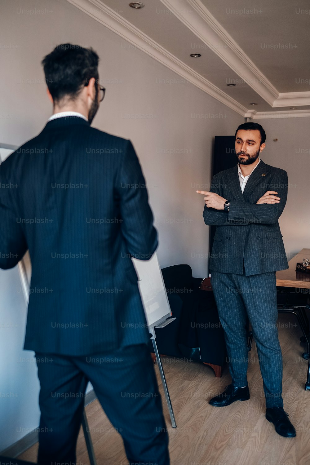 a man in a suit standing in a room