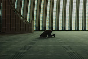 a person kneeling down in a large room