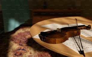 a violin sitting on top of sheet music on a table