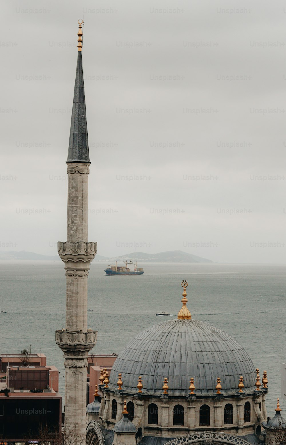 a view of a large building with a large body of water in the background