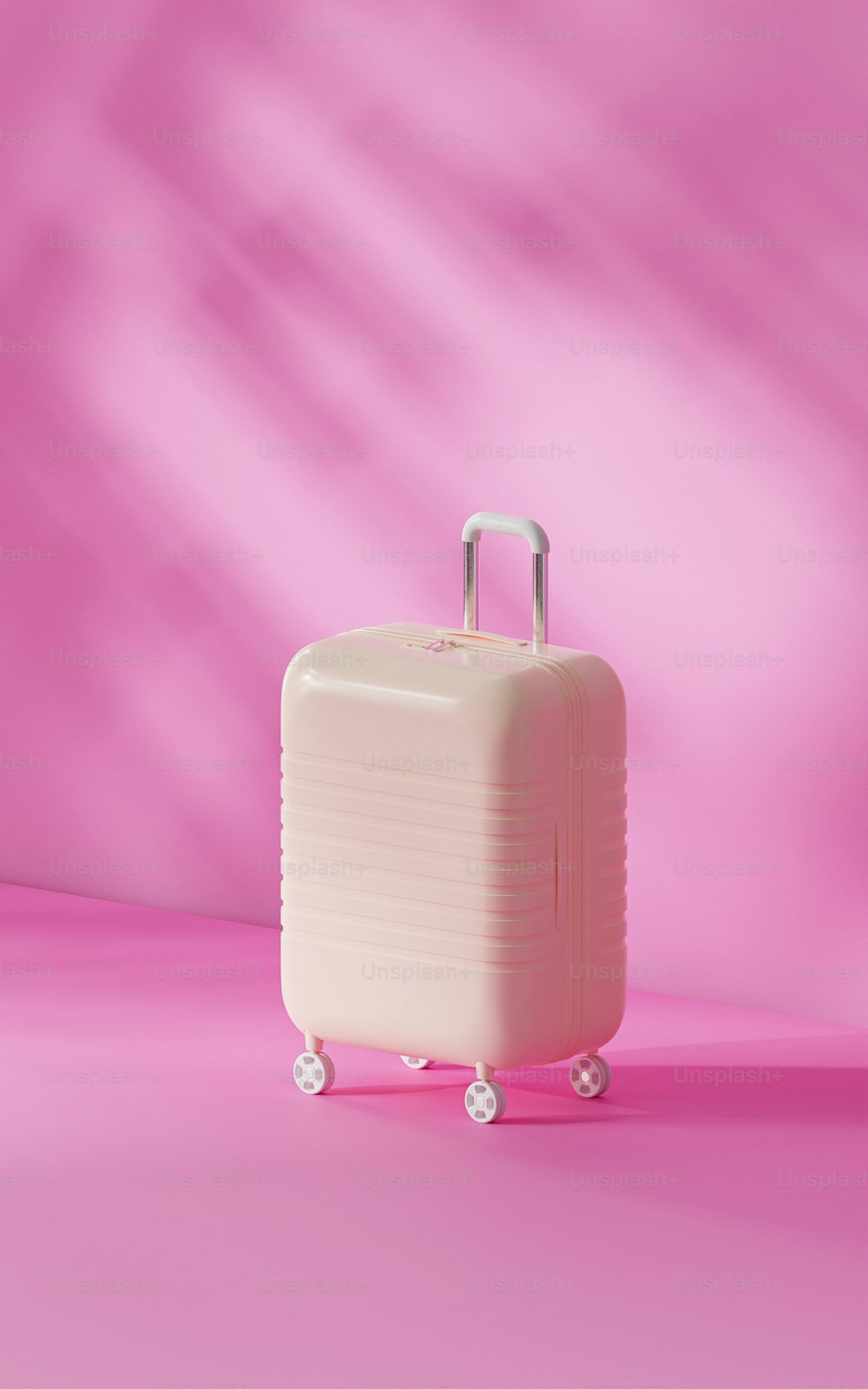 a white piece of luggage sitting on top of a pink floor