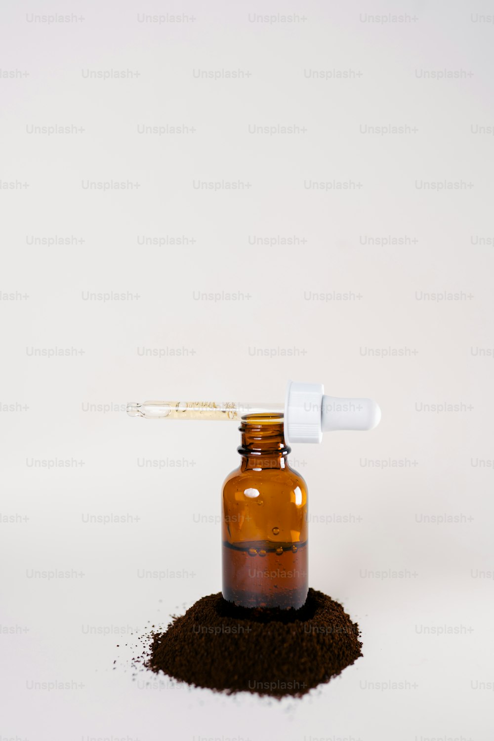 a bottle of brown stuff with a dropper on top of it