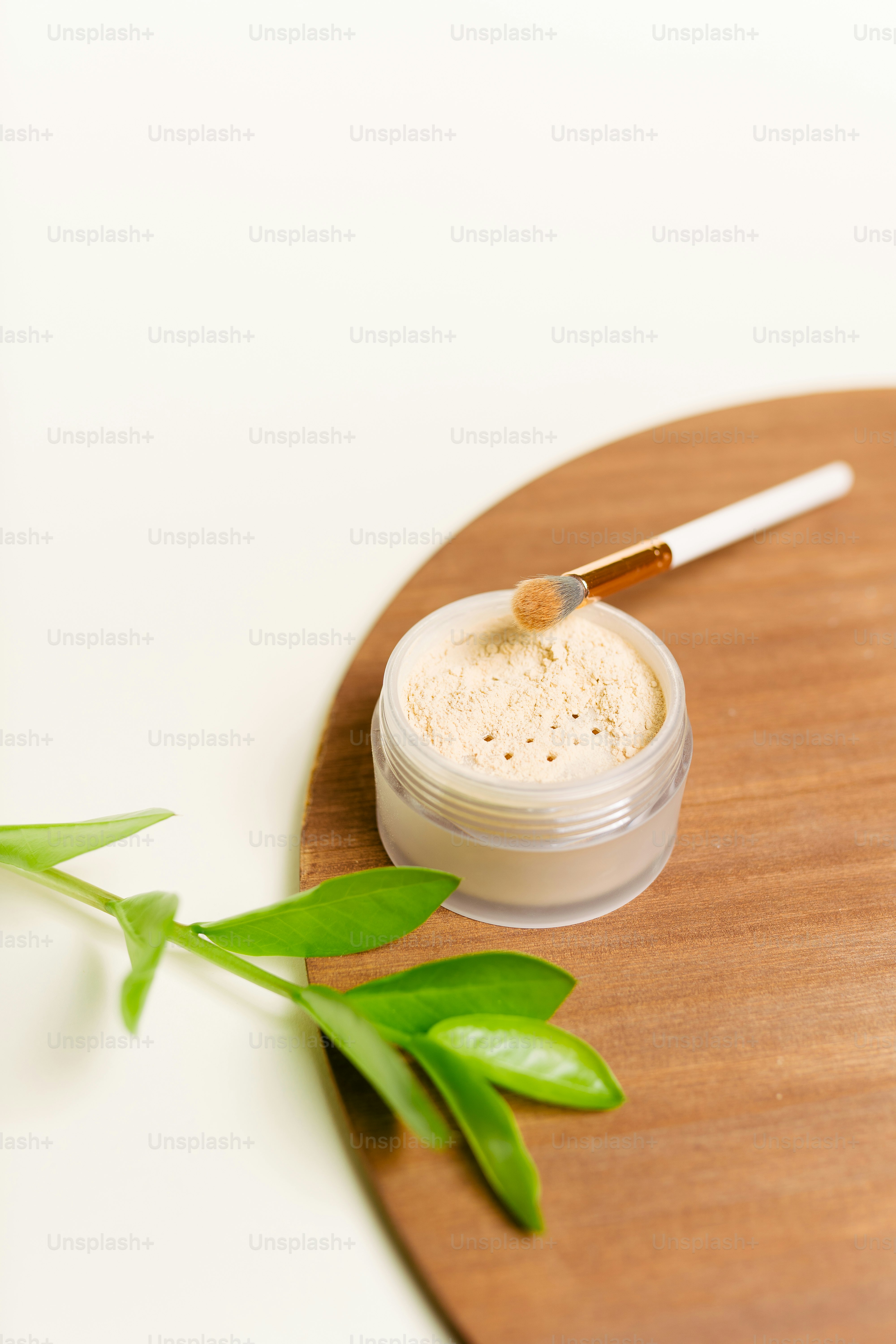 a small jar of white powder on a wooden tray