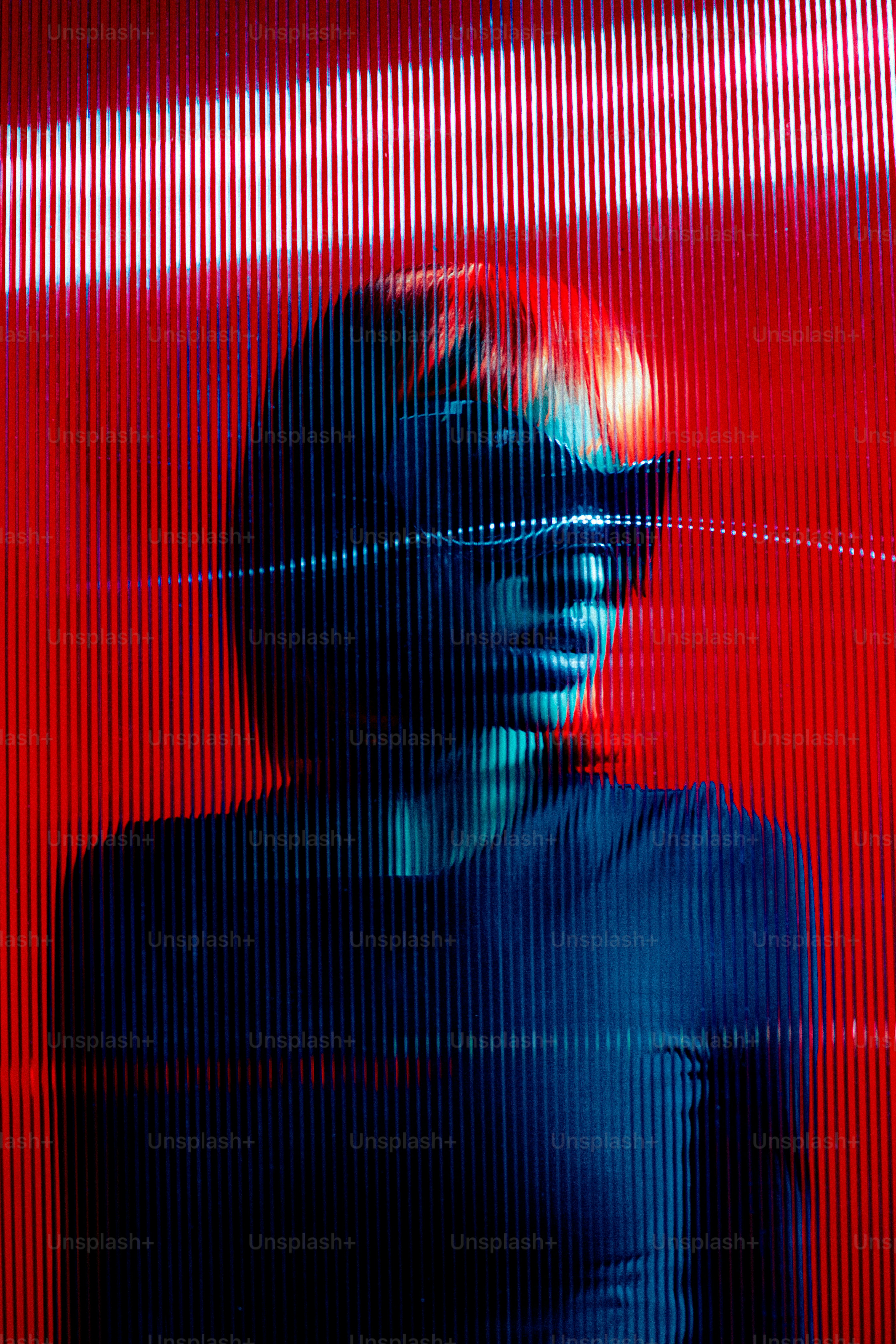 a man standing in front of a red wall