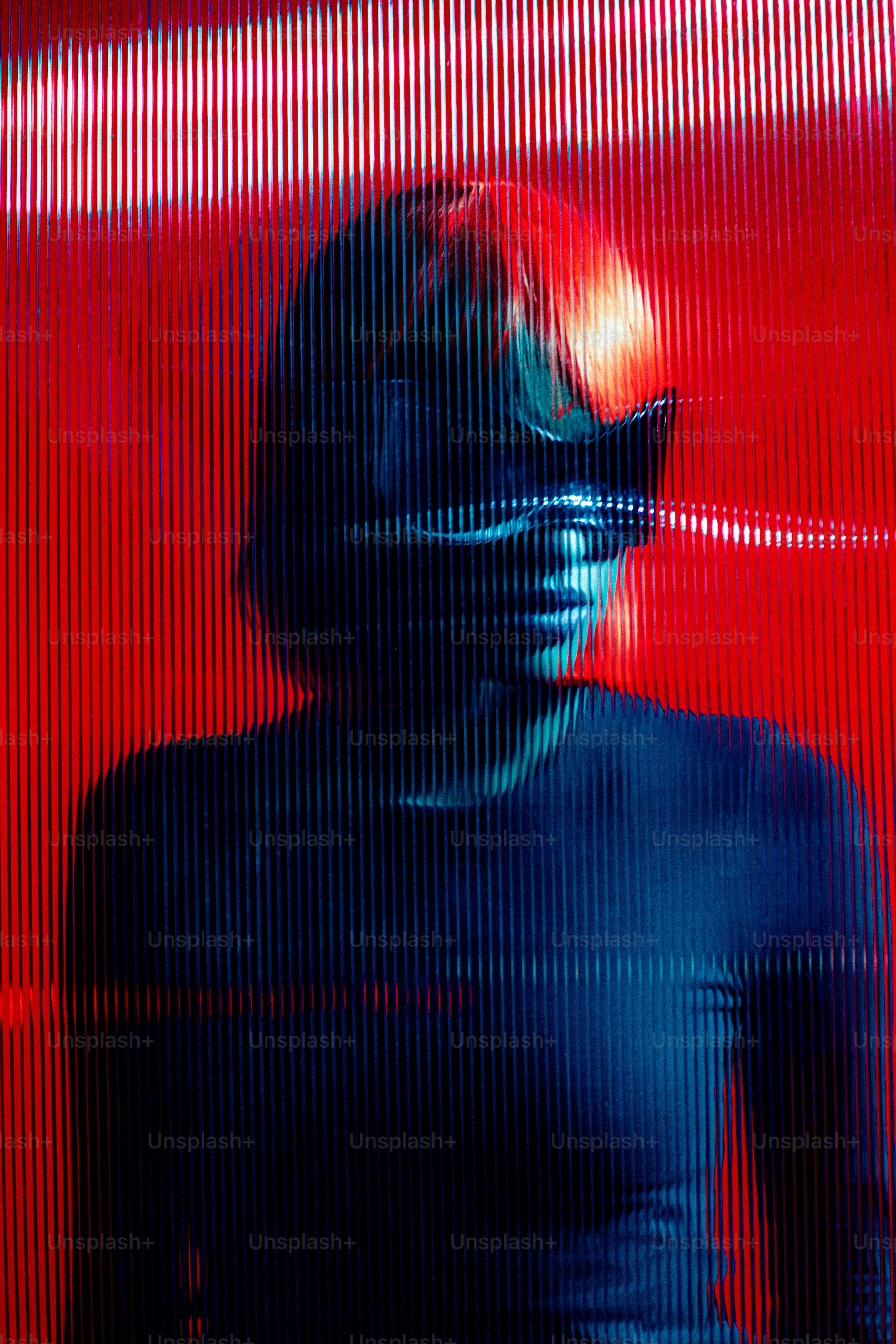 A man standing in front of a red wall photo – Abstract Image on Unsplash
