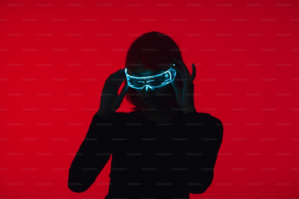 a woman in a black shirt wearing a neon mask