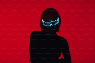 a woman in a black dress with a neon mask on