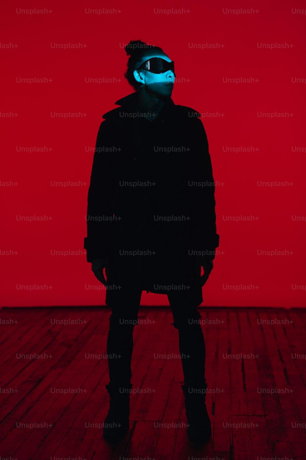 a person standing in a room with a red background