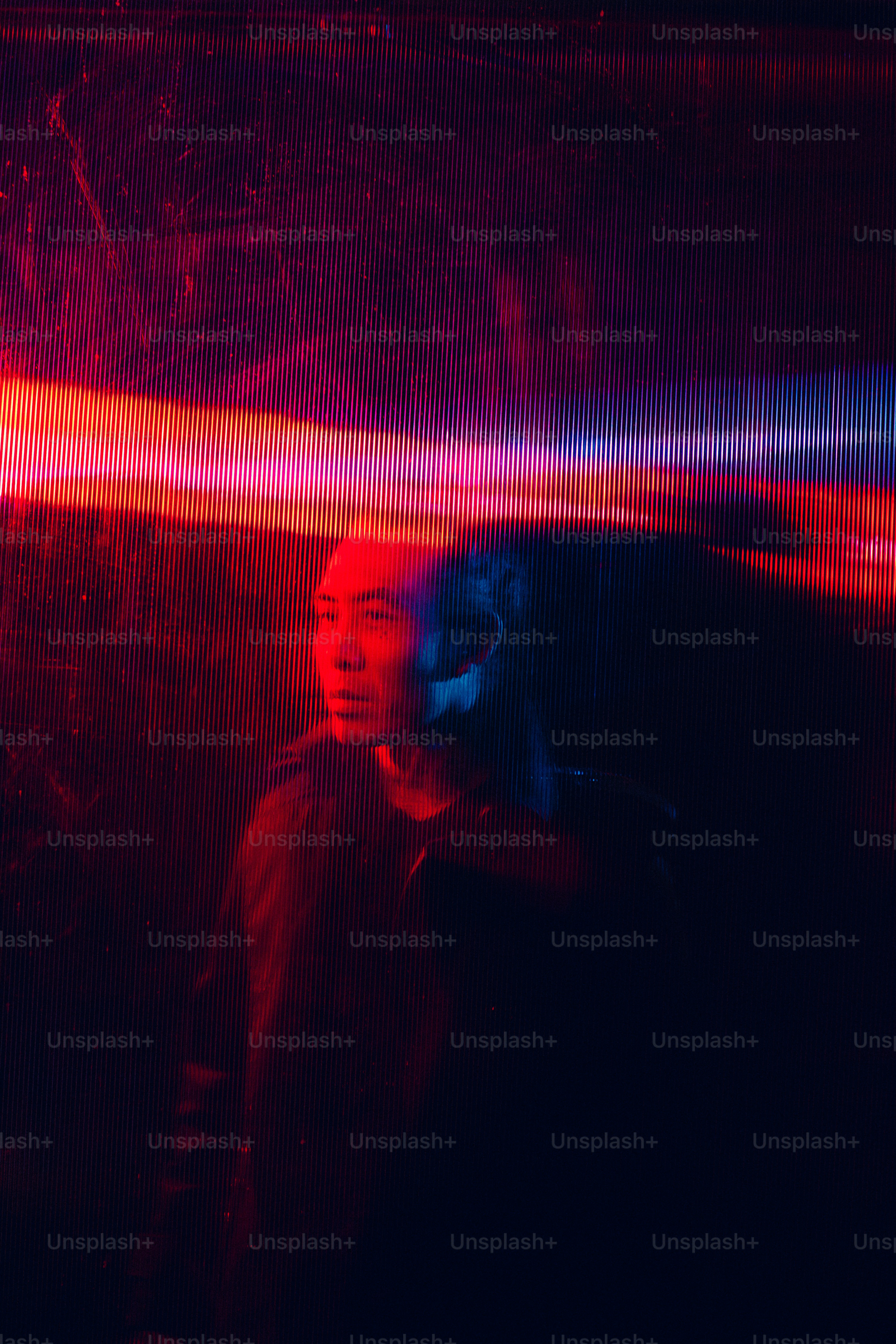 A woman standing in front of a red wall photo – Abstract Image on Unsplash