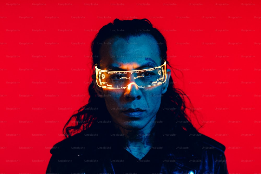 a man with long hair wearing a pair of glowing glasses