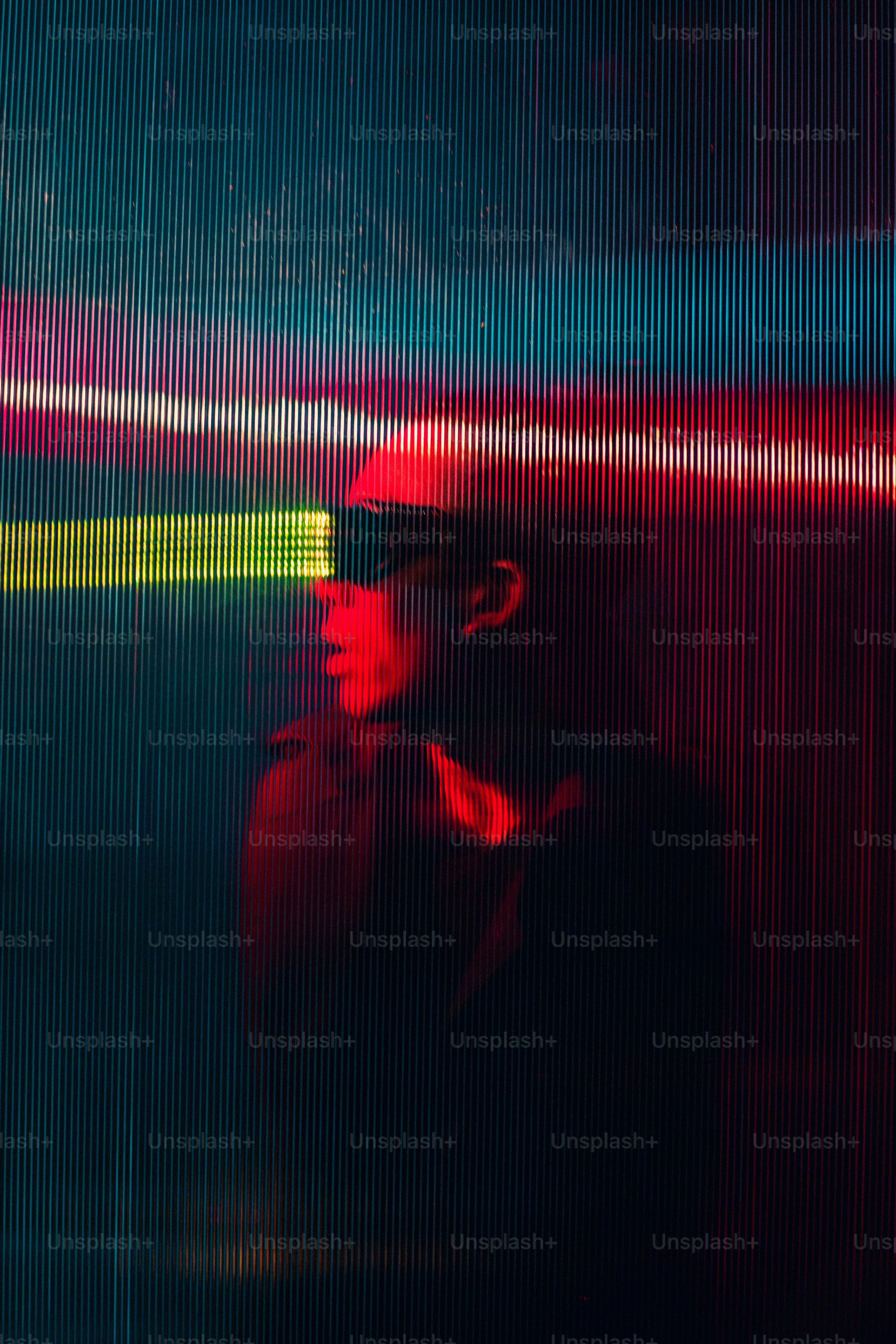 a man in a red hat and sunglasses standing in front of a screen