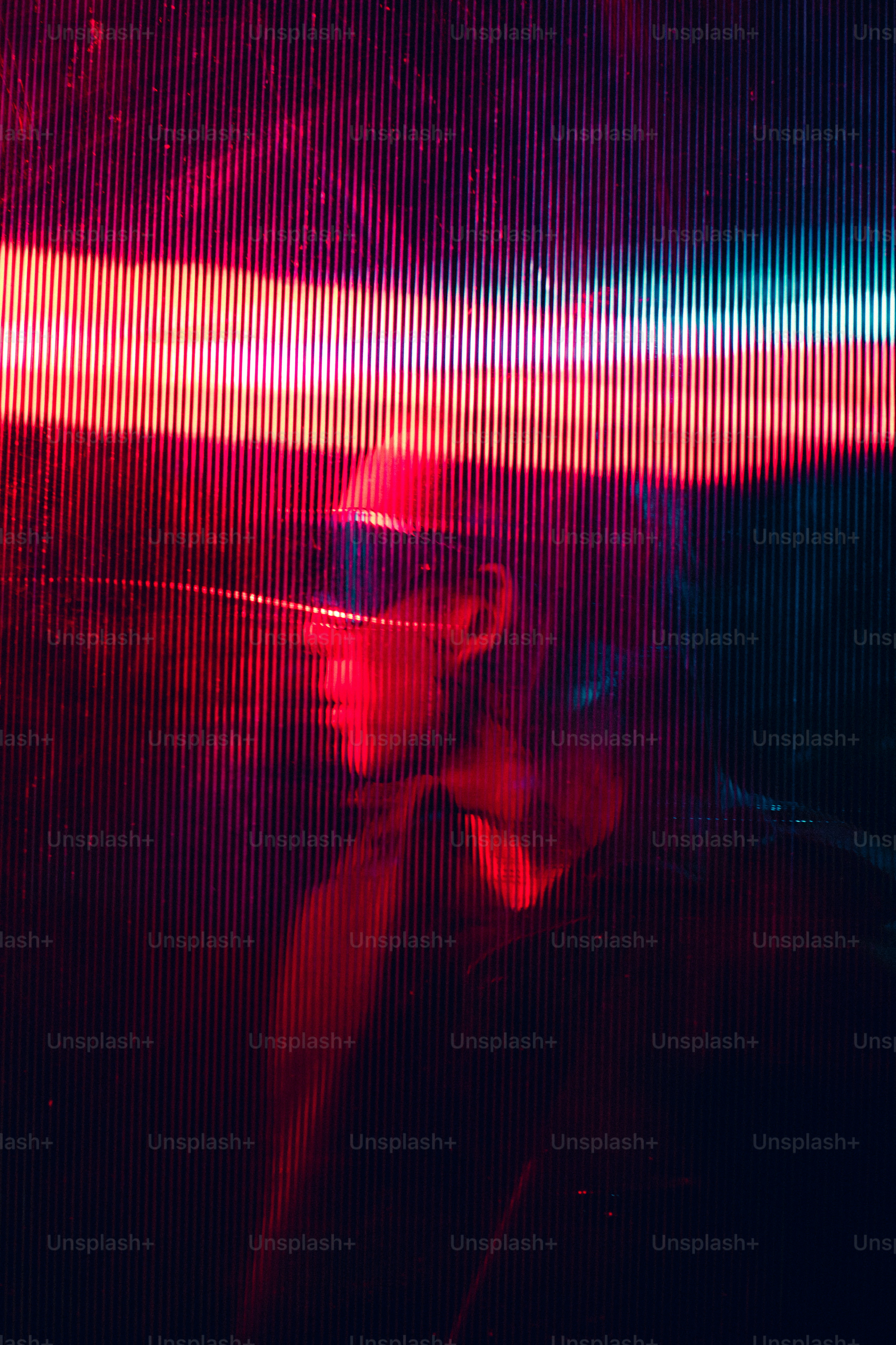 A man wearing a hat and sunglasses standing in front of a window photo ...