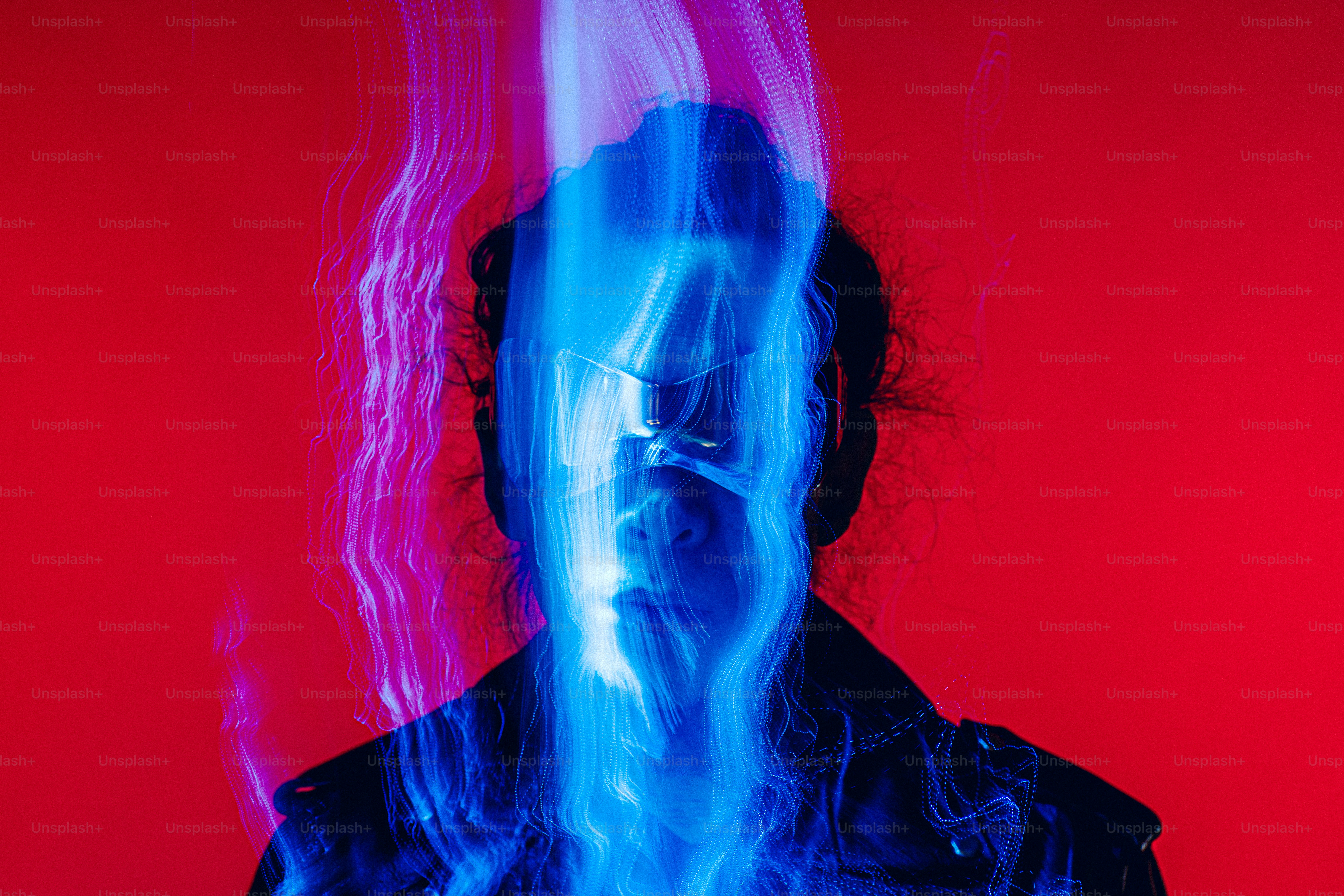 a man in a black jacket with a red and blue background