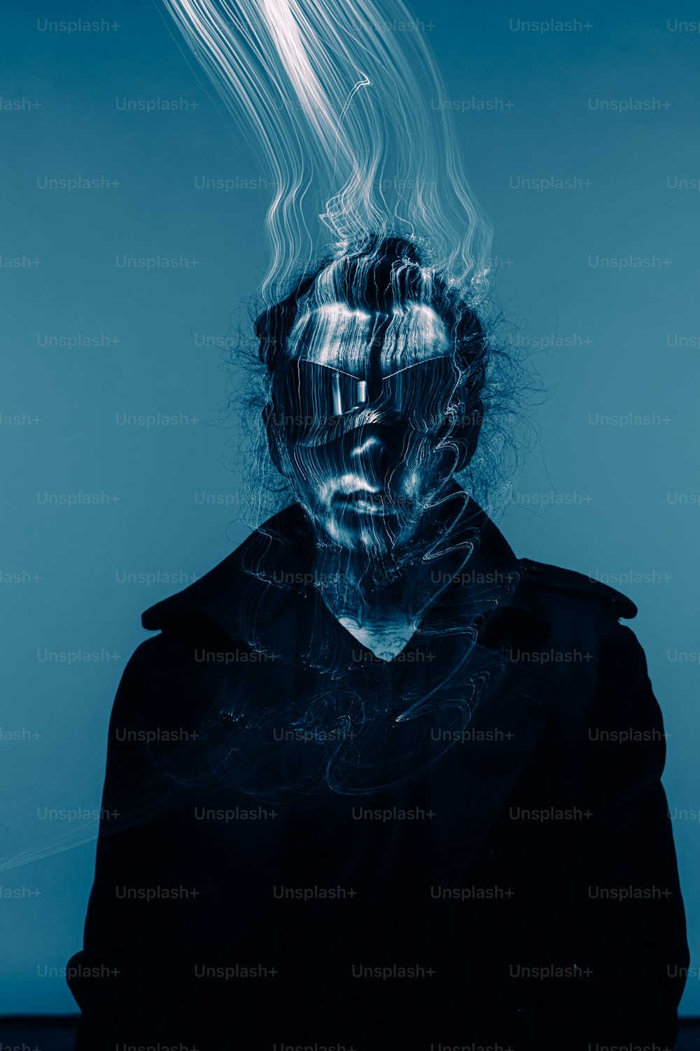 a man with his face obscured by smoke