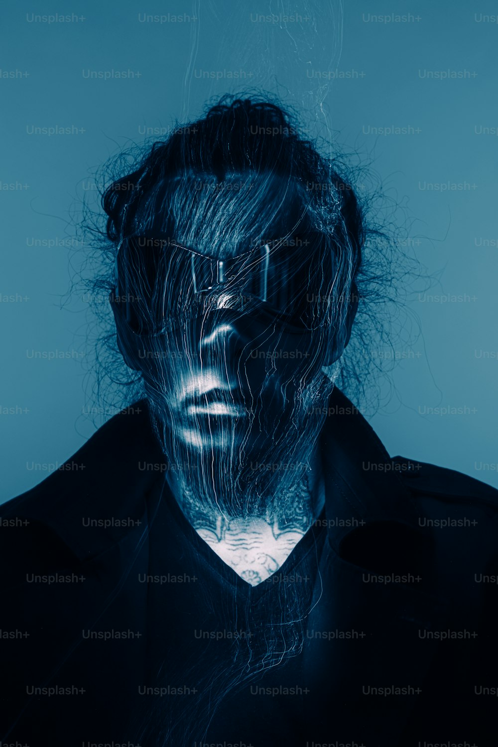 a man's face is covered in blue light