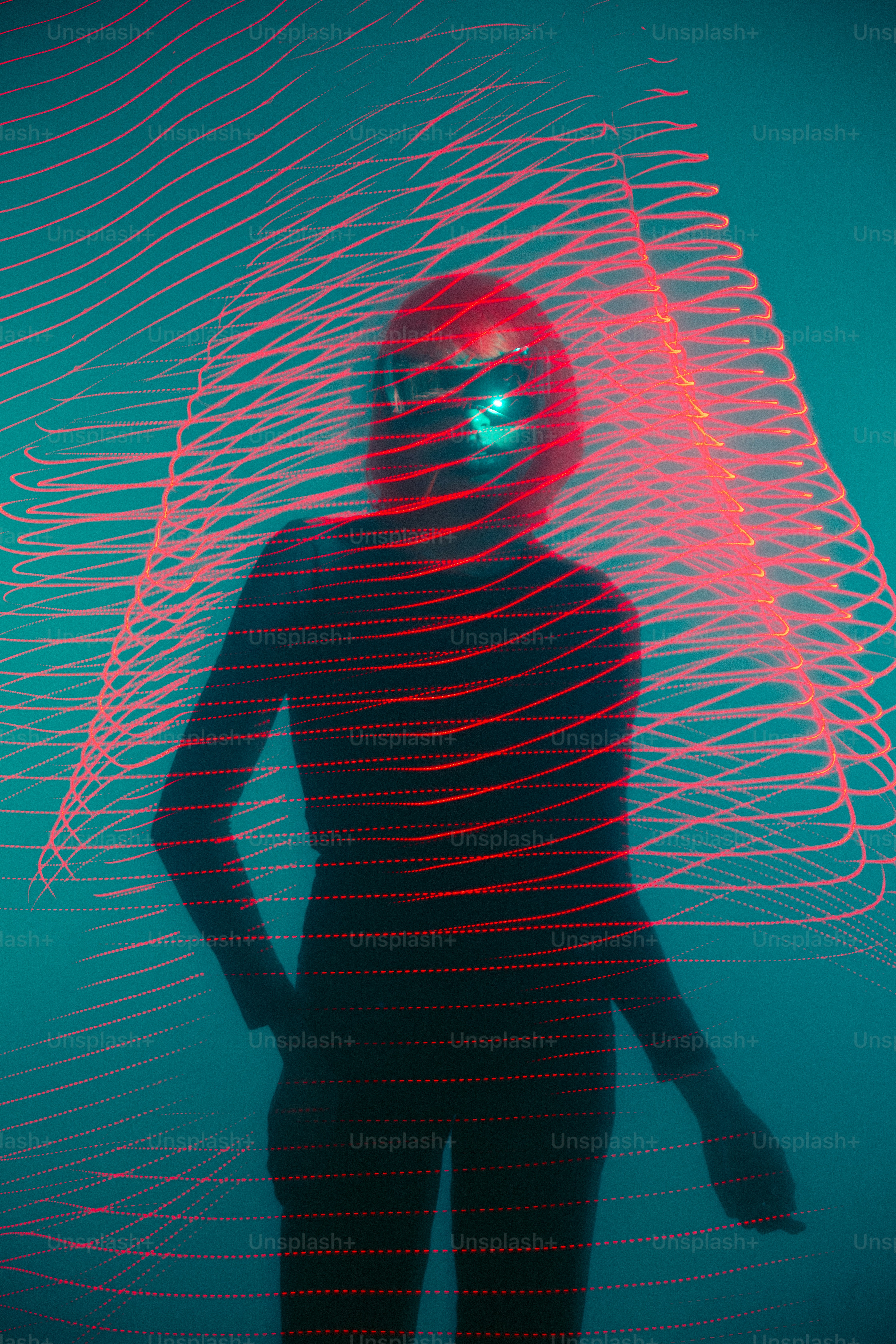 a man standing in front of a red light