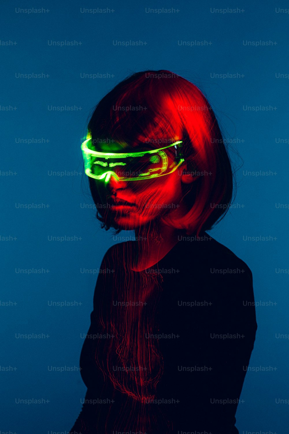 a woman wearing neon glasses against a blue background
