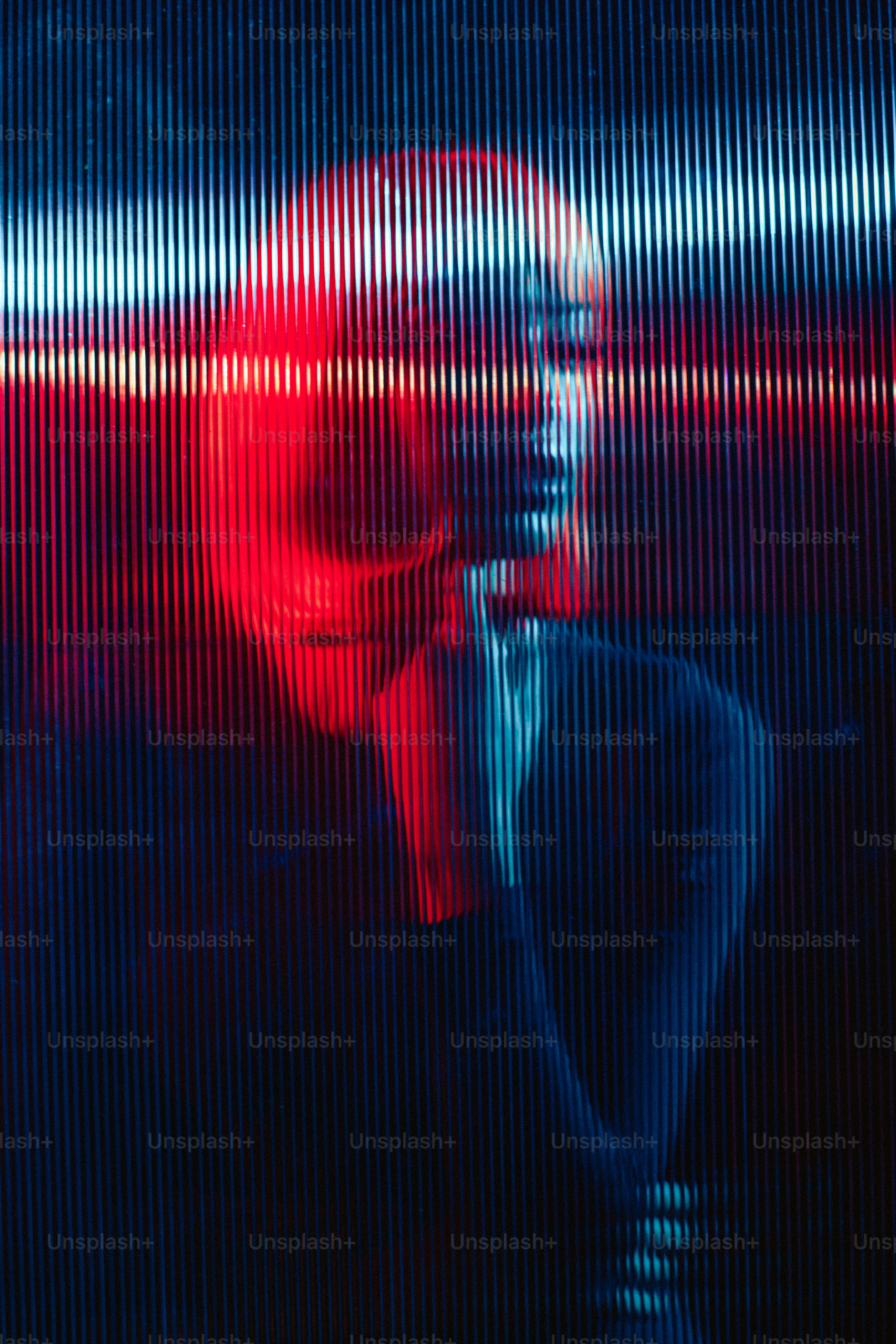 a man in a suit and tie standing in front of a red and blue background