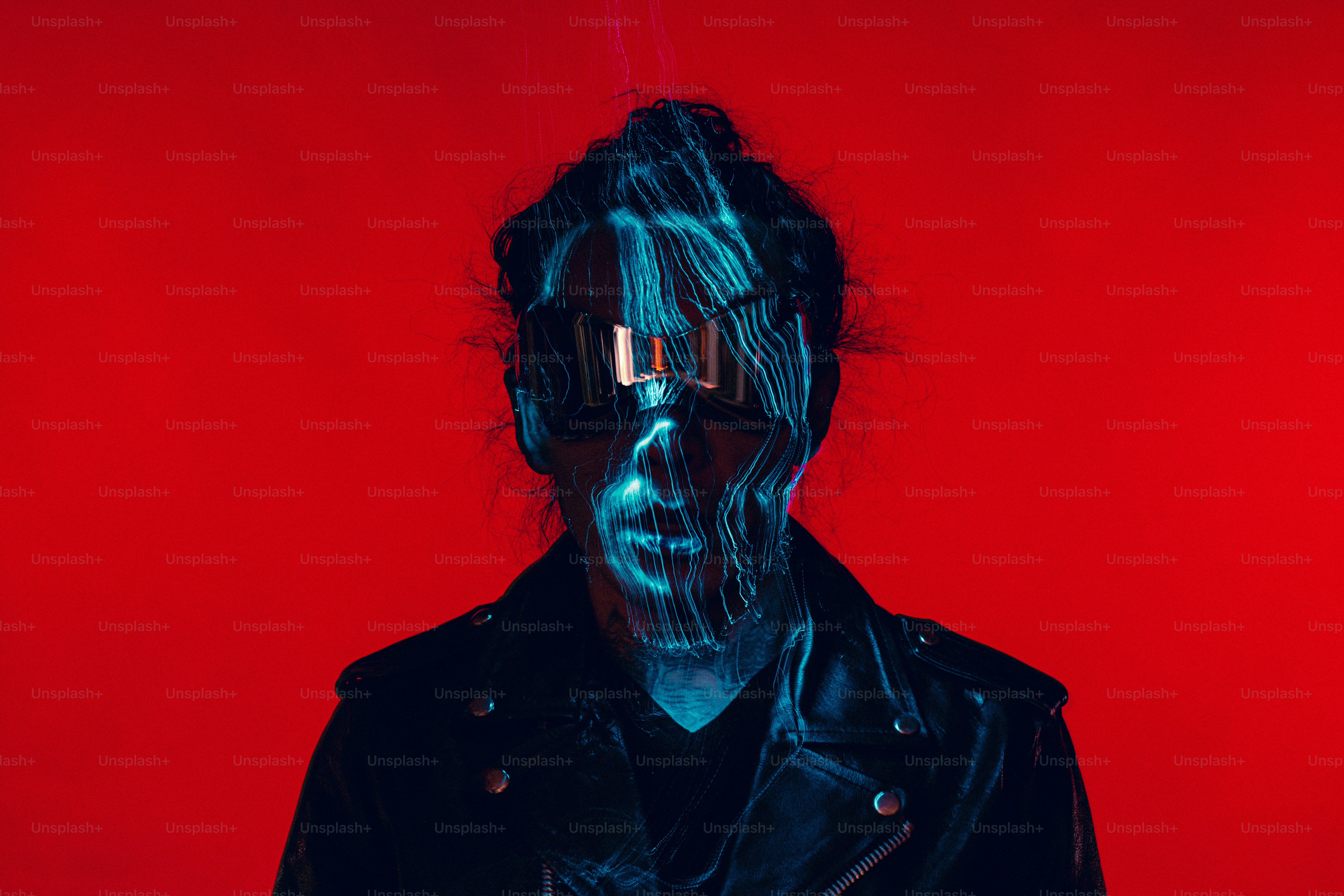 a man in a black leather jacket with a red background