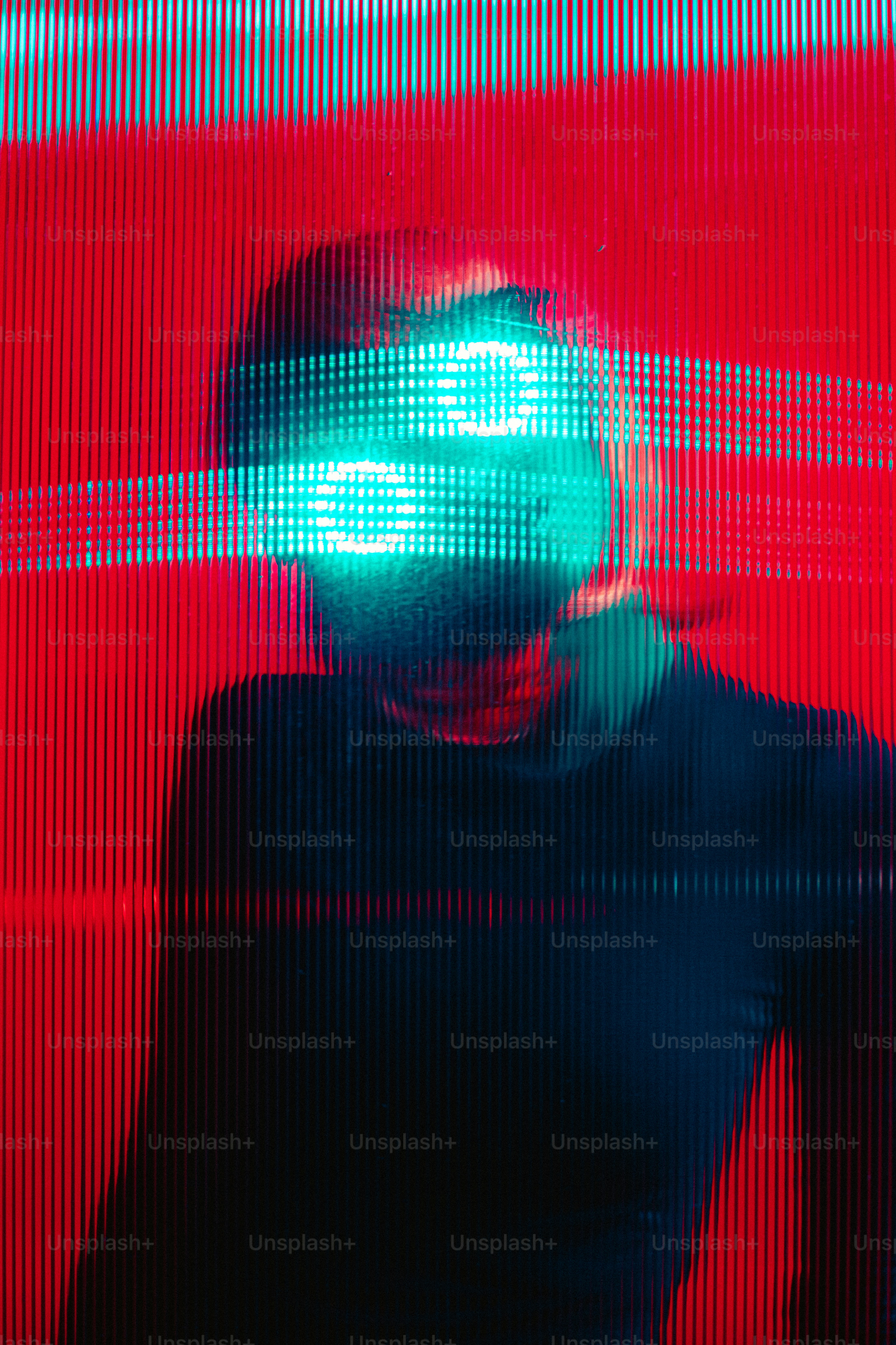 a woman standing in front of a red wall