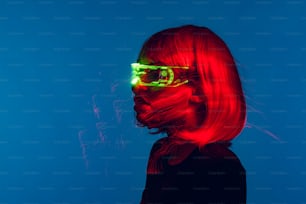 a woman with red hair and neon glasses