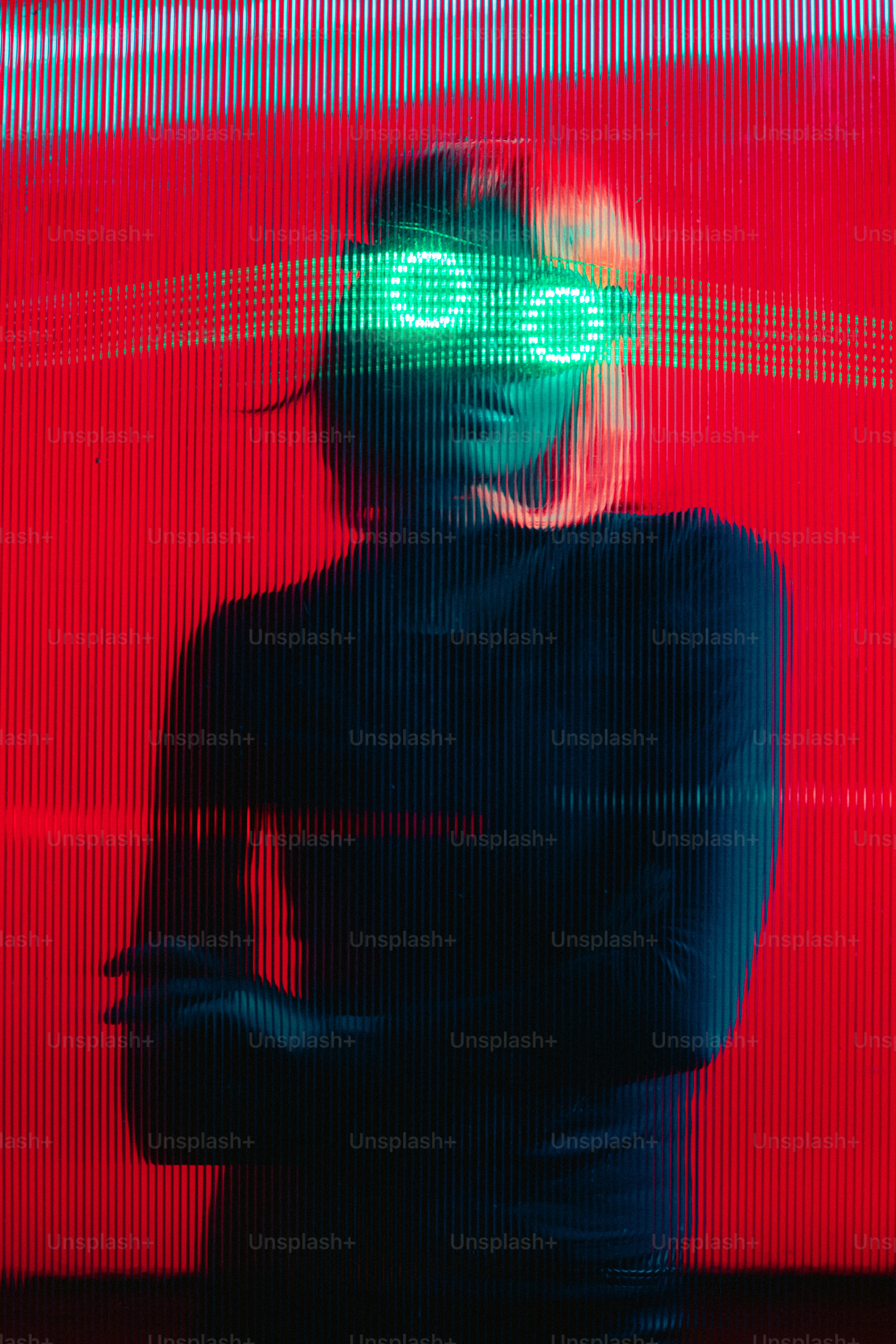 a woman in a black dress and green goggles standing in front of a red