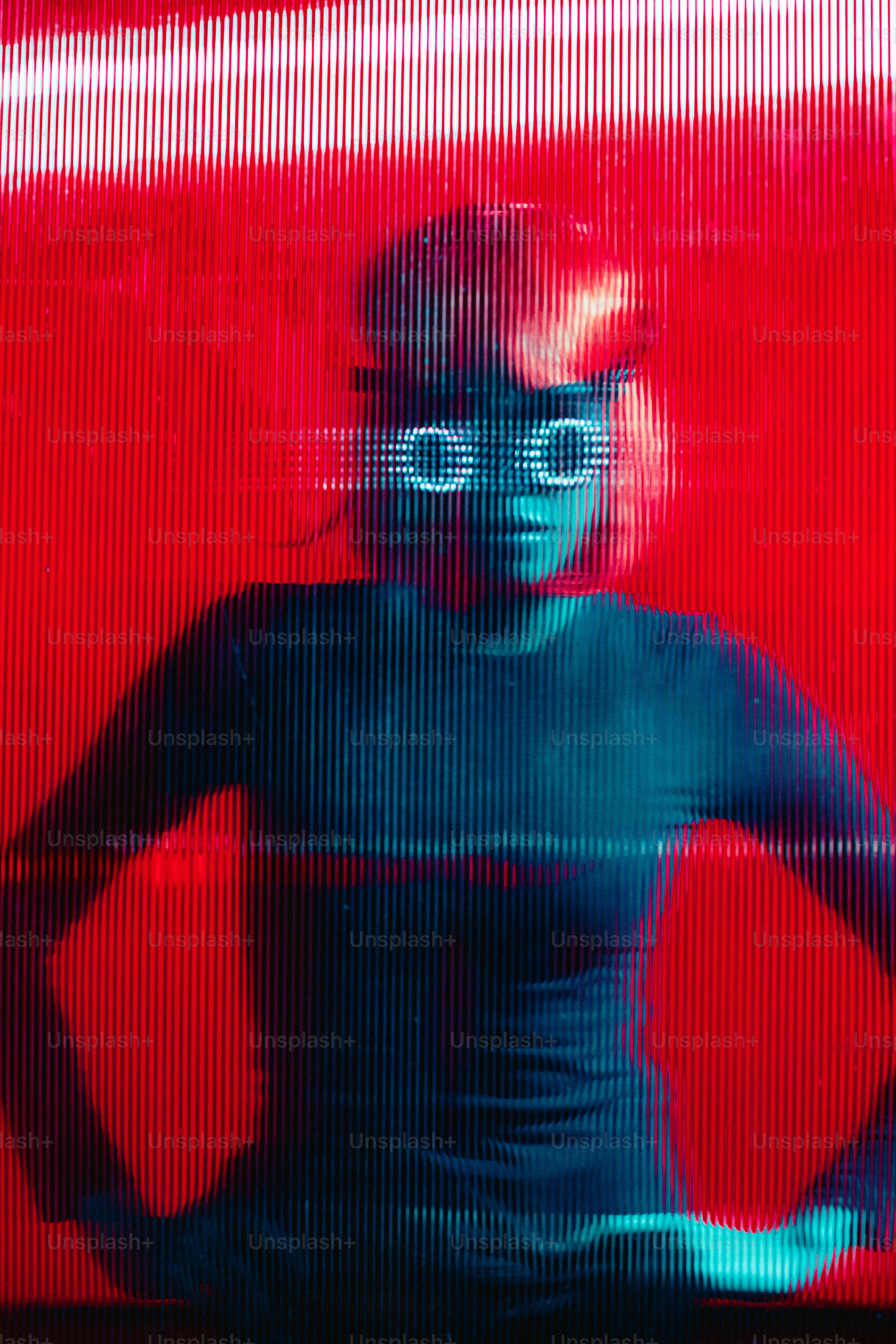 A woman standing in front of a red wall photo – Portrait Image on Unsplash