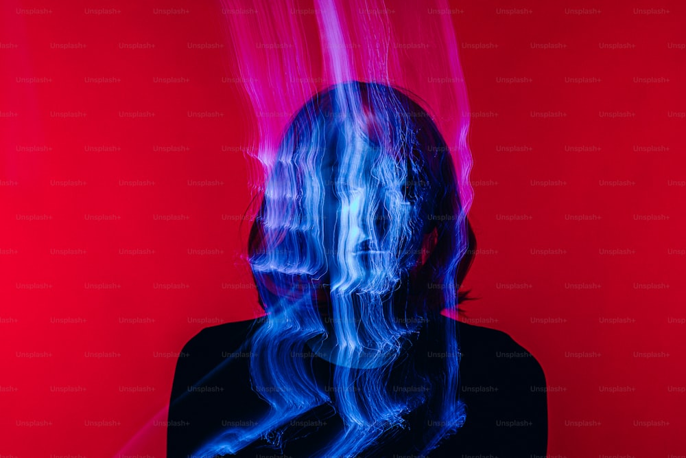 a woman's face with blue and pink smoke coming out of it