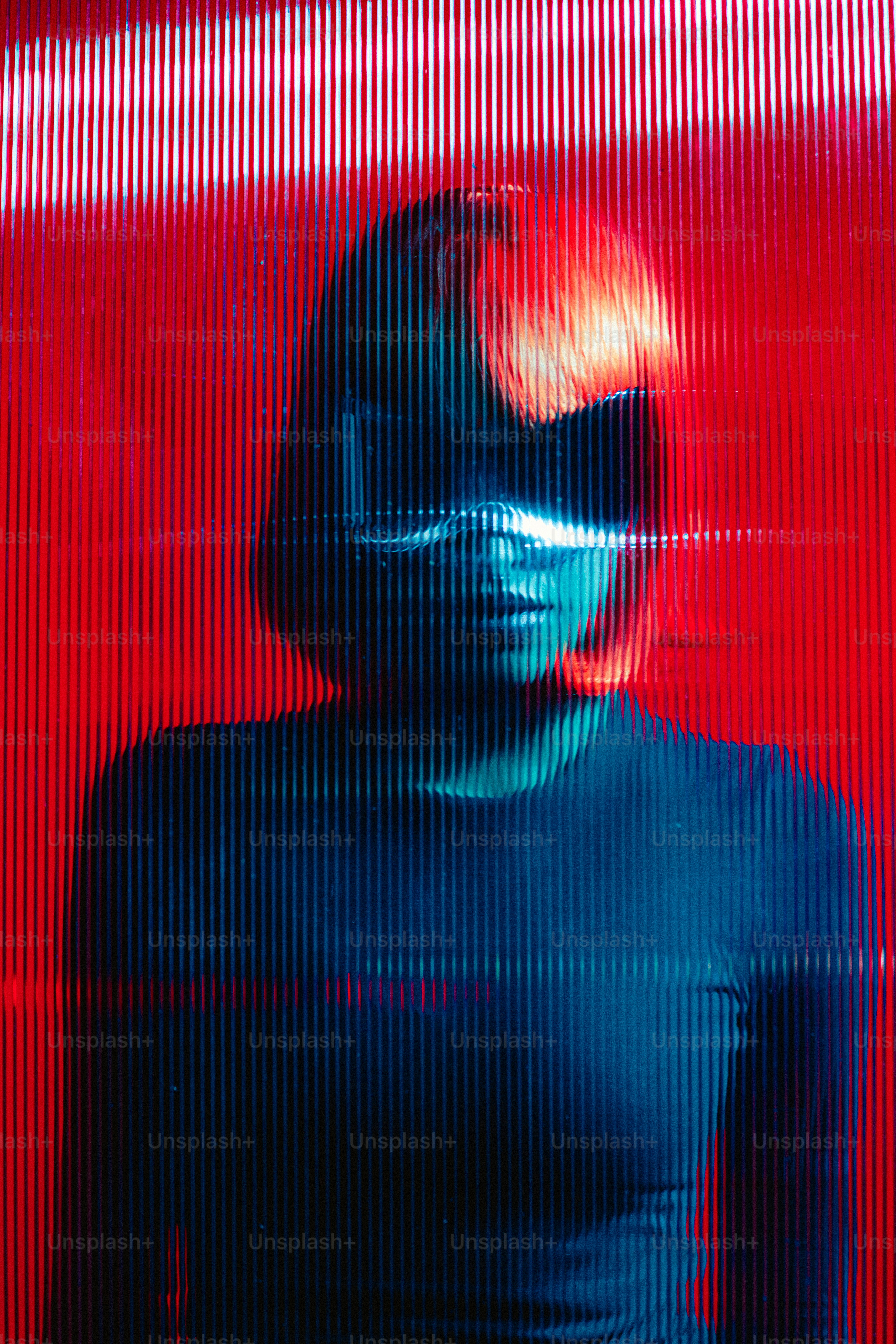 a woman standing in front of a red wall