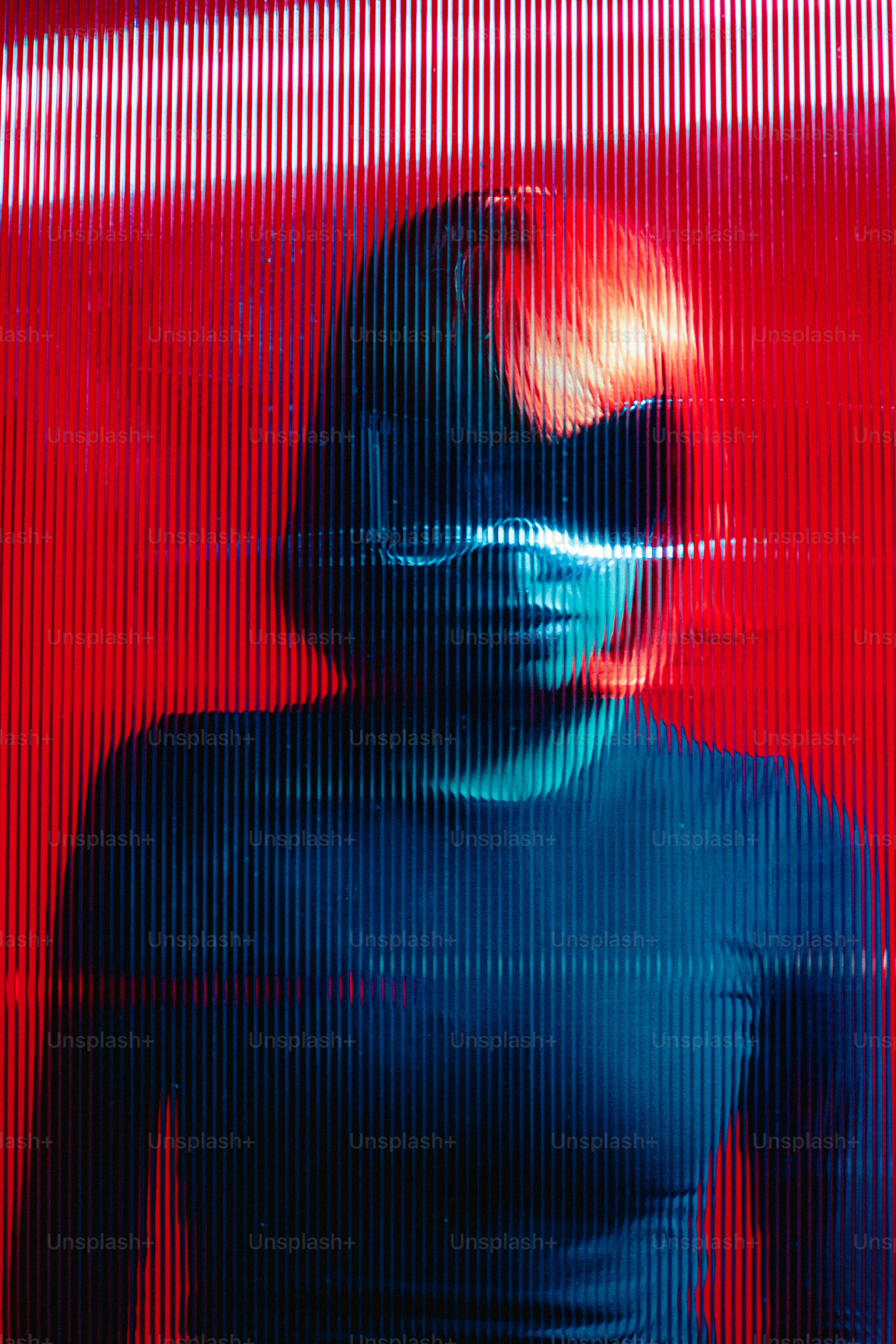 a woman in a black shirt is standing in front of a red wall