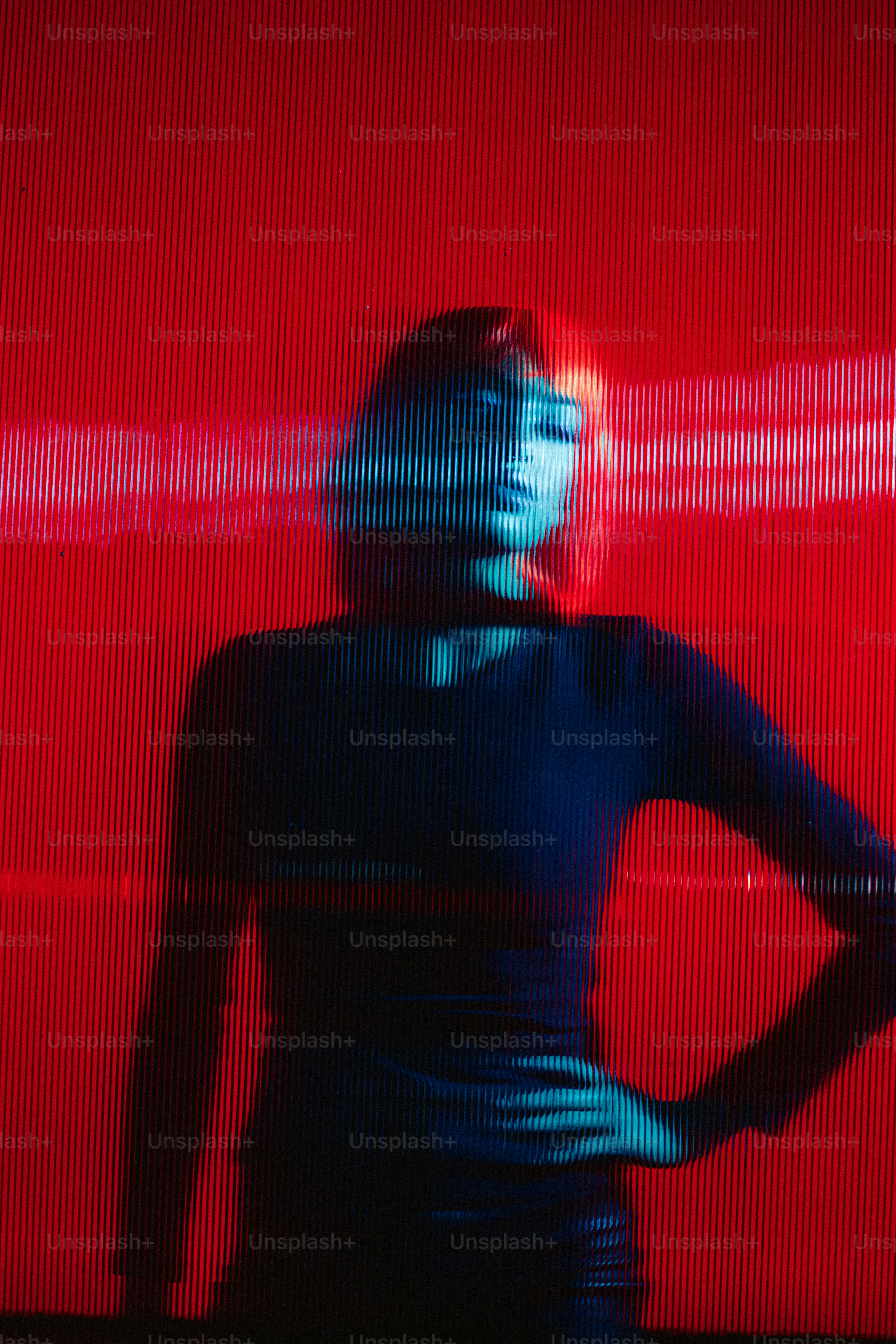 a woman standing in front of a red wall