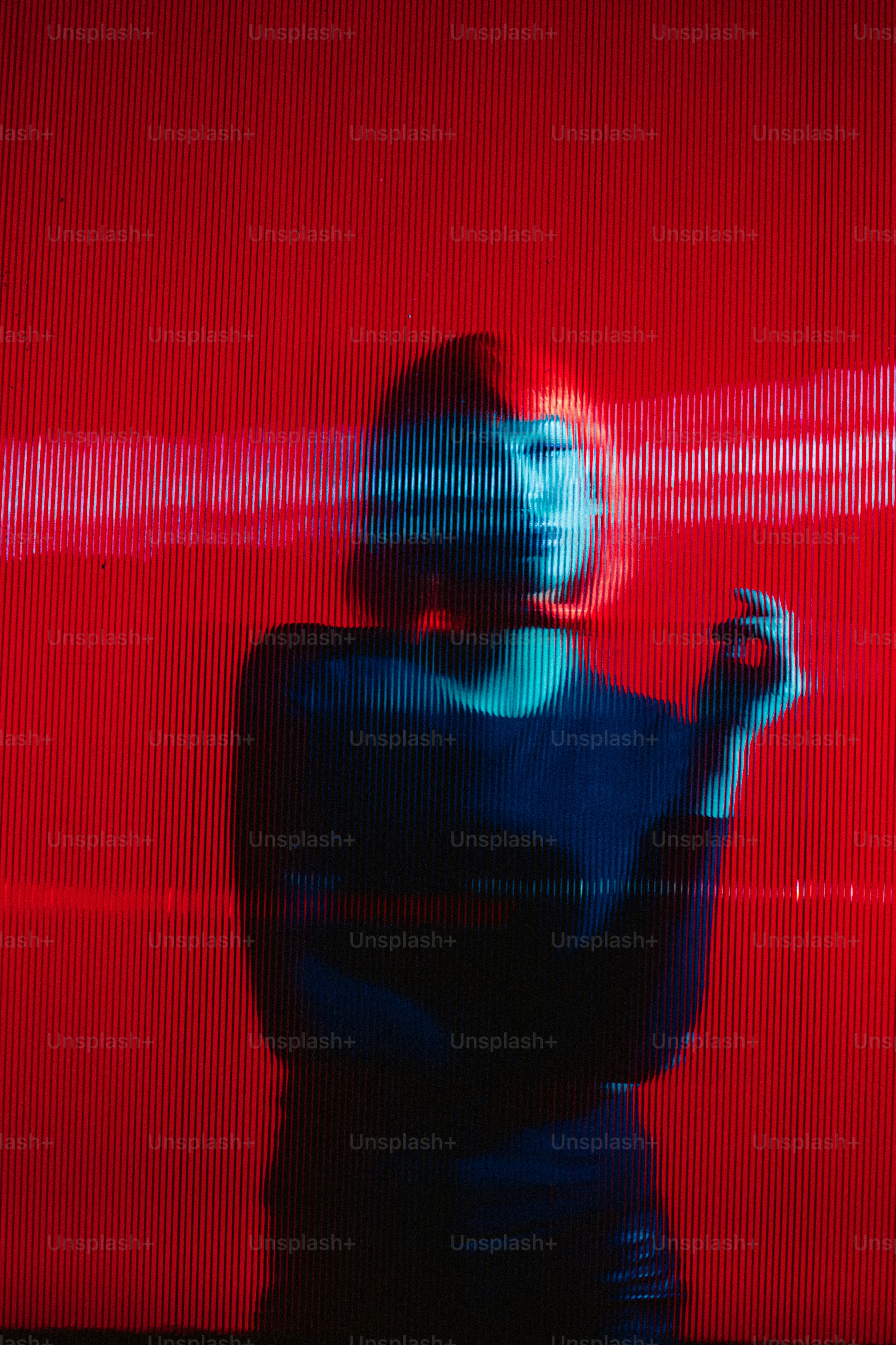 a woman standing in front of a red wall