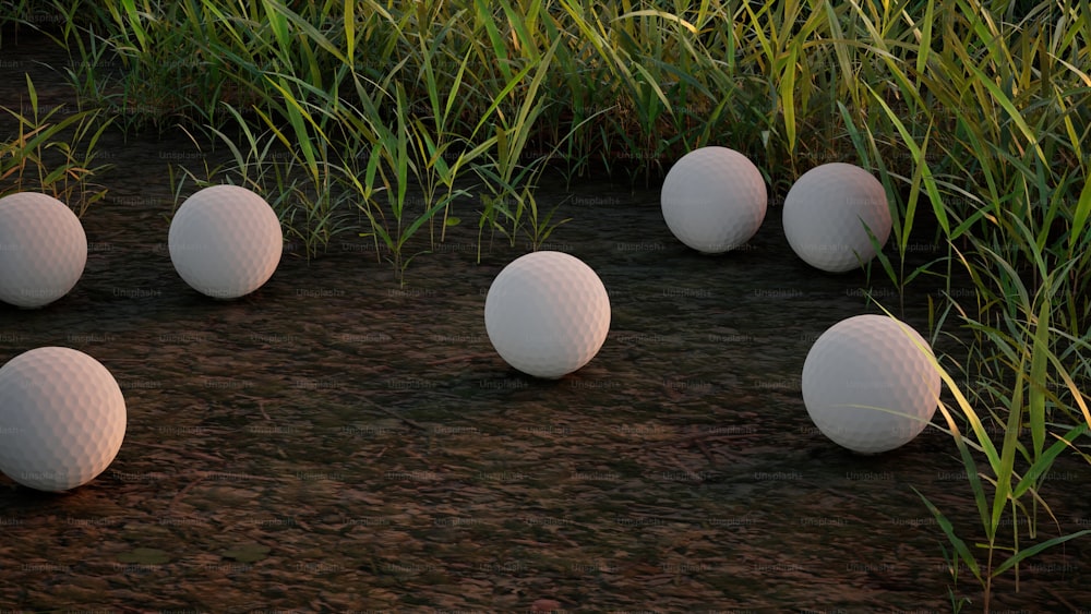 a bunch of white golf balls sitting in the grass