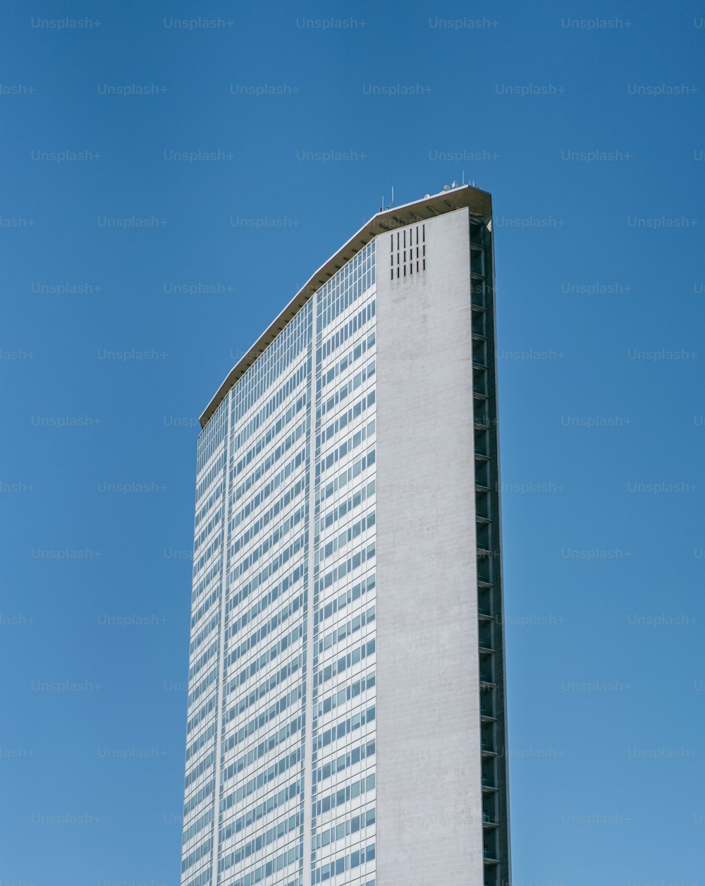 a tall white building sitting on the side of a road