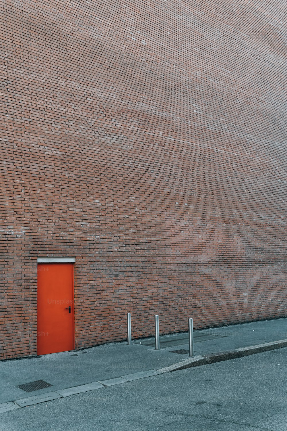 a brick building with a red door on the side of it