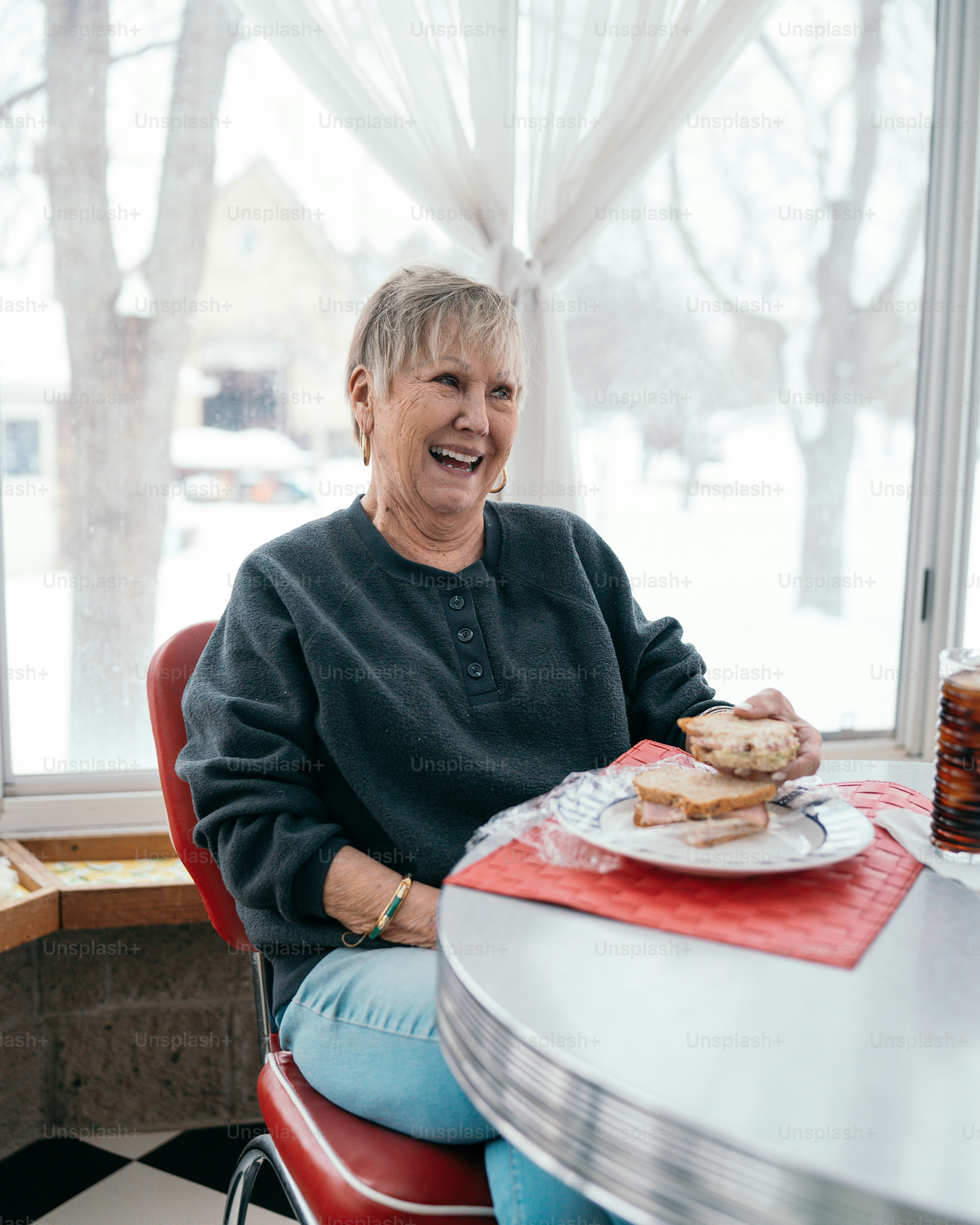 a woman sitting at a table with a plate of food