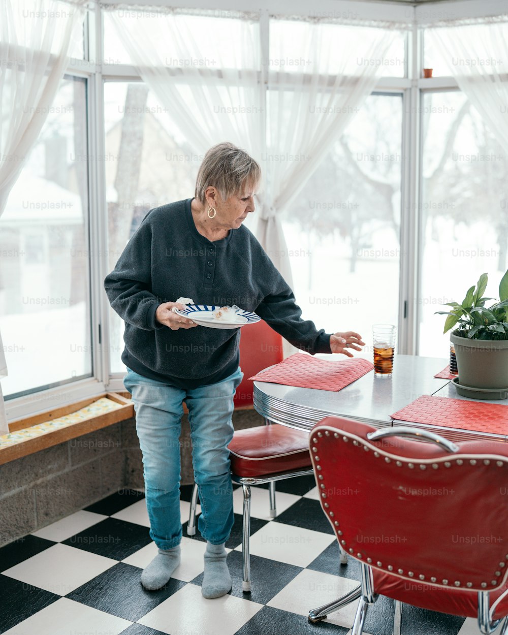 a man holding a plate of food at a table