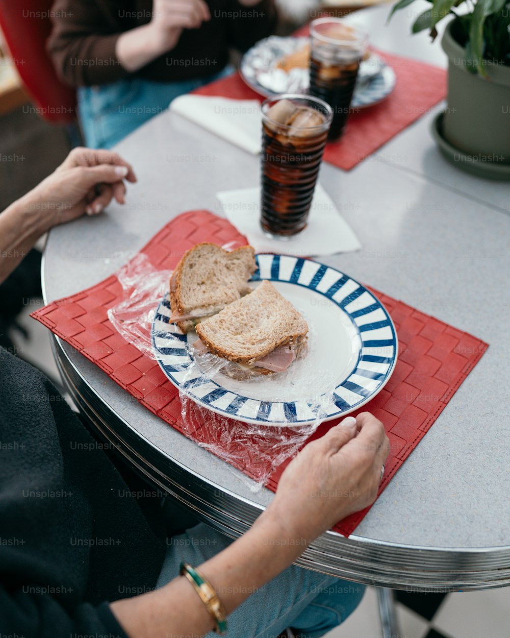 a person sitting at a table with a plate of food