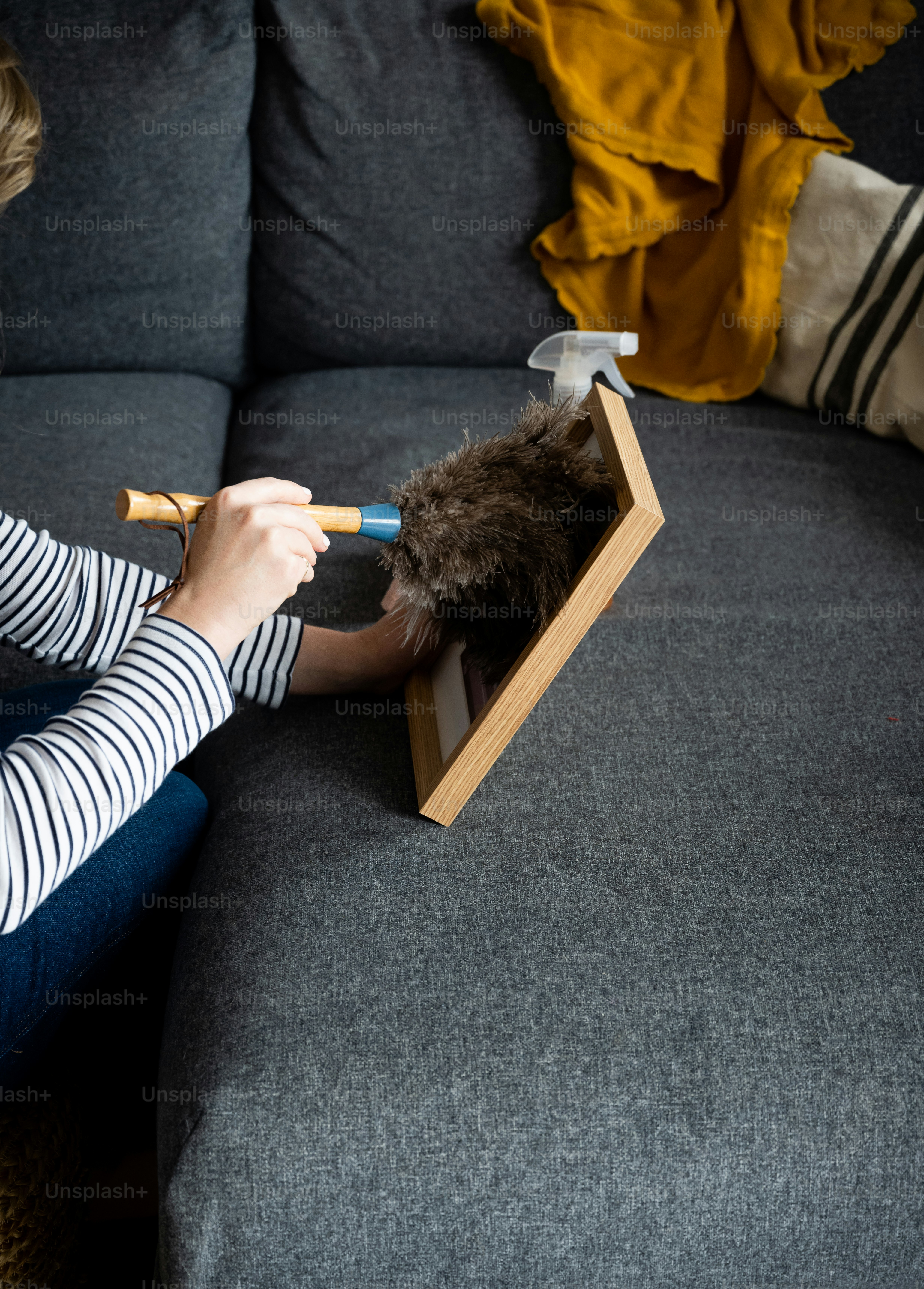 a woman sitting on top of a couch holding a pair of scissors